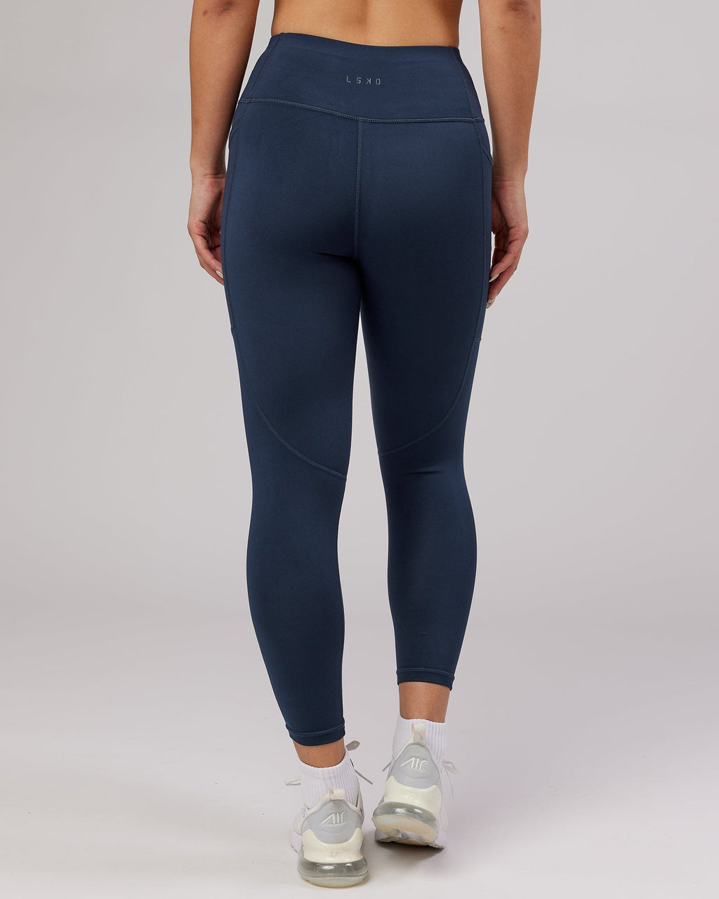 Model wearing Rep 7/8 Length Tight - Navy