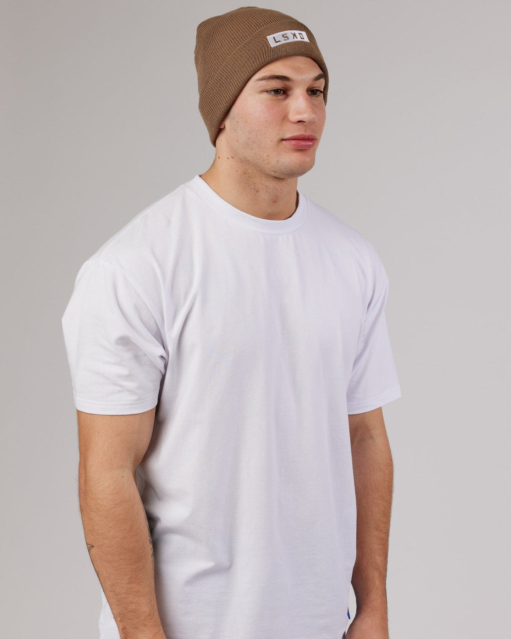 Model wearing Cornerstone Beanie - Fossil