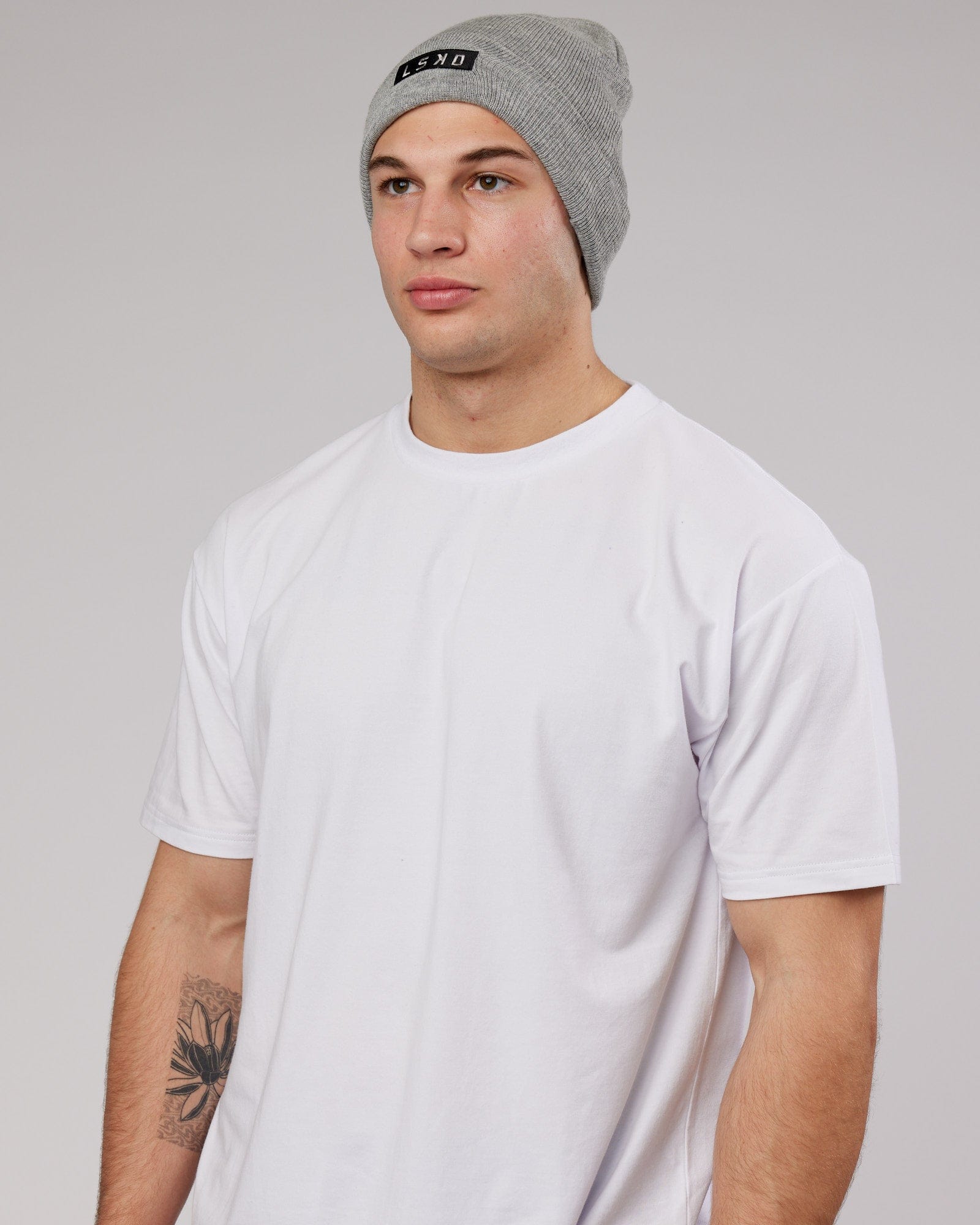 Model wearing Cornerstone Beanie - Lt Grey Marl