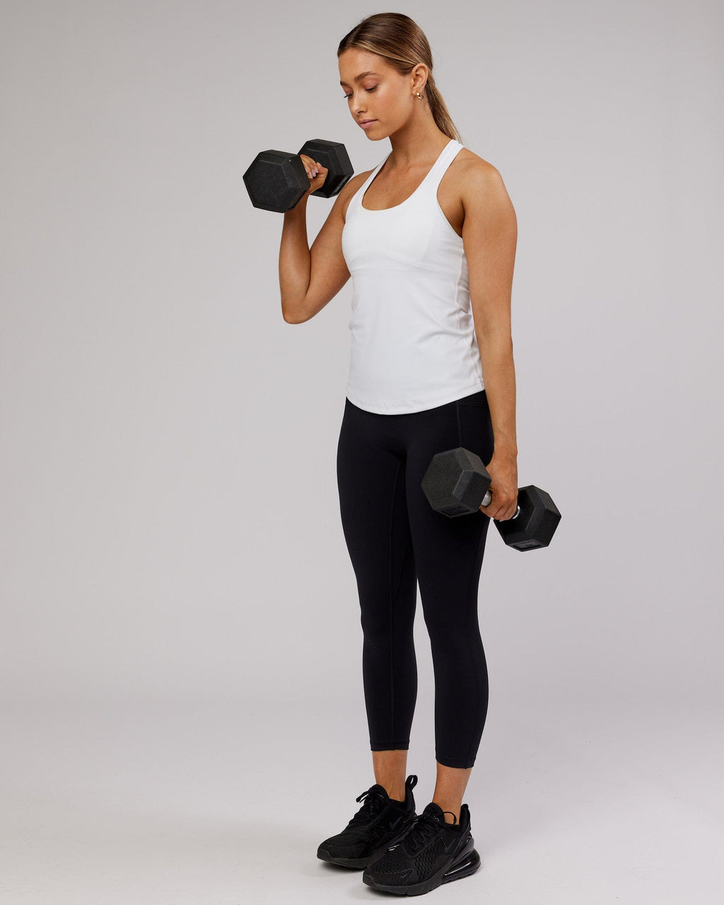 Model wearing Lift Performance Tank - White