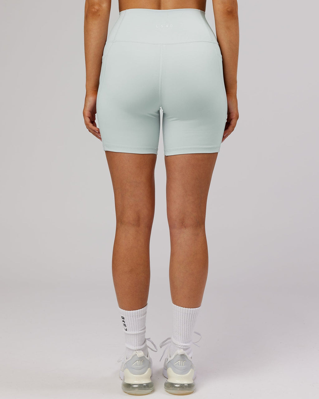 Model wearing Fusion Mid Short TIght - Ballad Blue