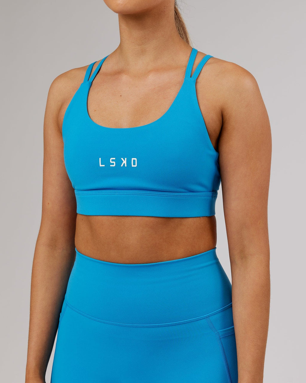 Model wearing Bridge Sports Bra - Ibiza Blue