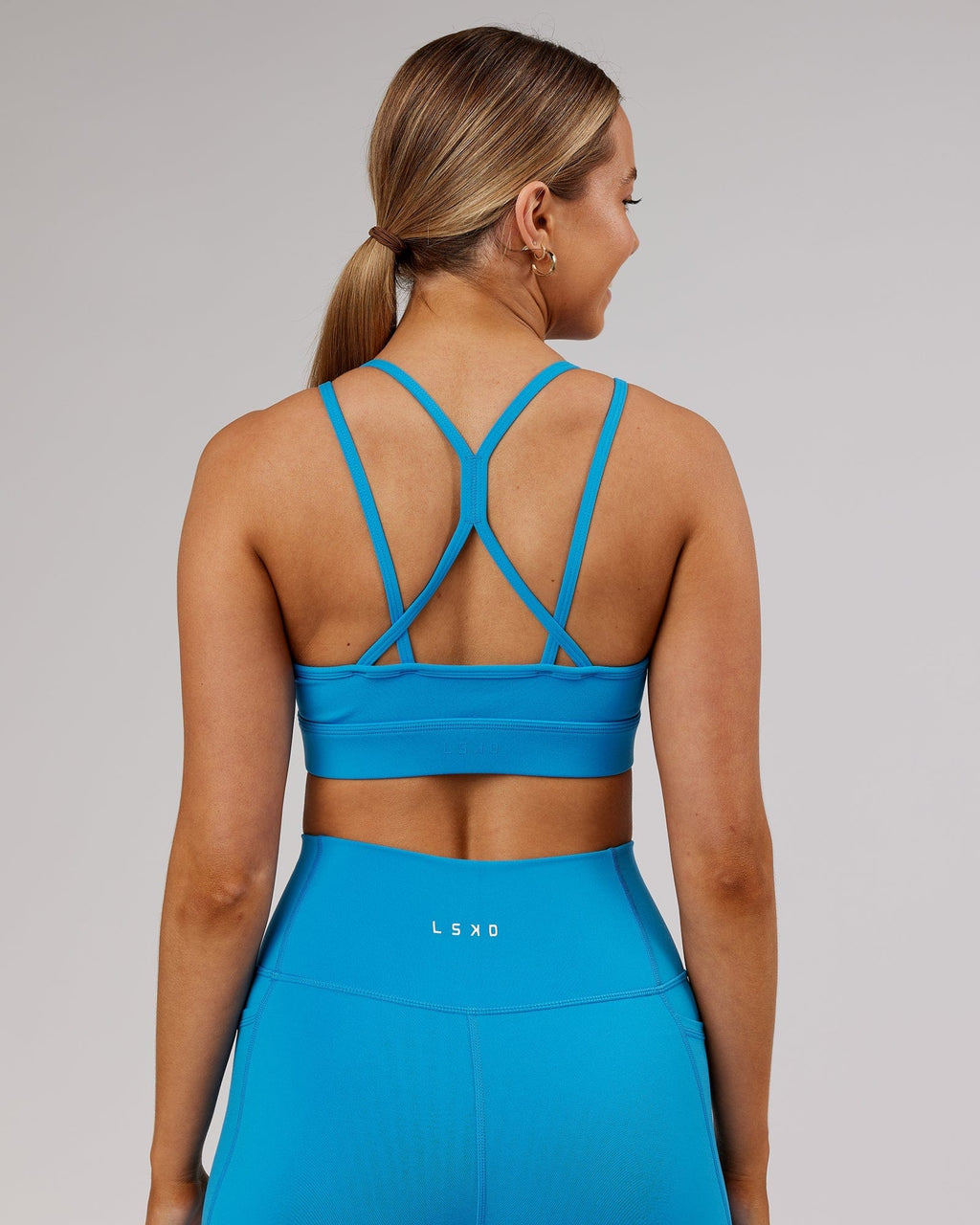 Model wearing Bridge Sports Bra - Ibiza Blue