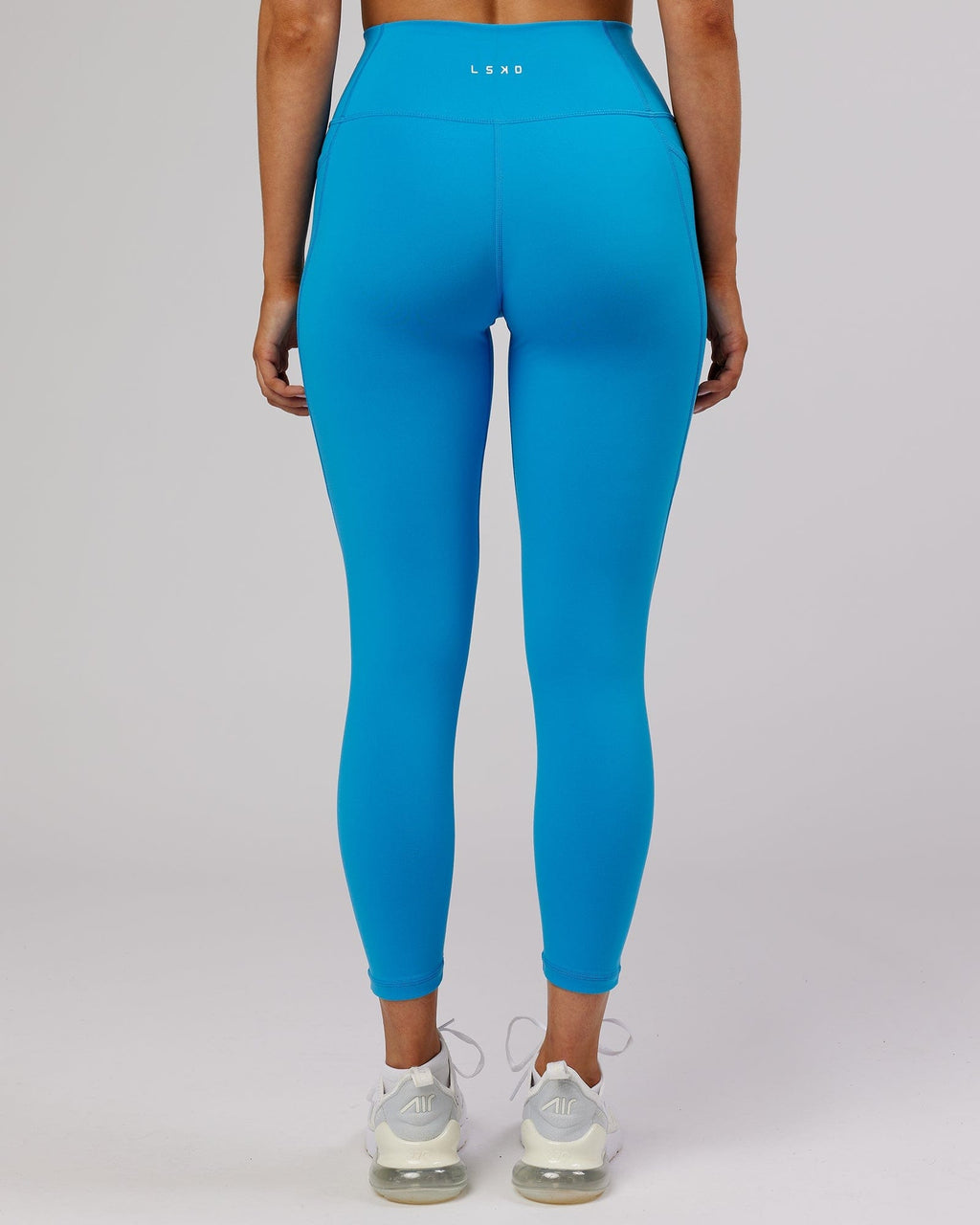 Model wearing Fusion 7/8 Length Tight - Ibiza Blue