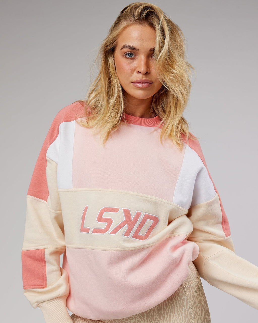 Model wearing Unisex Slam Oversize Sweater - Peach Multi
