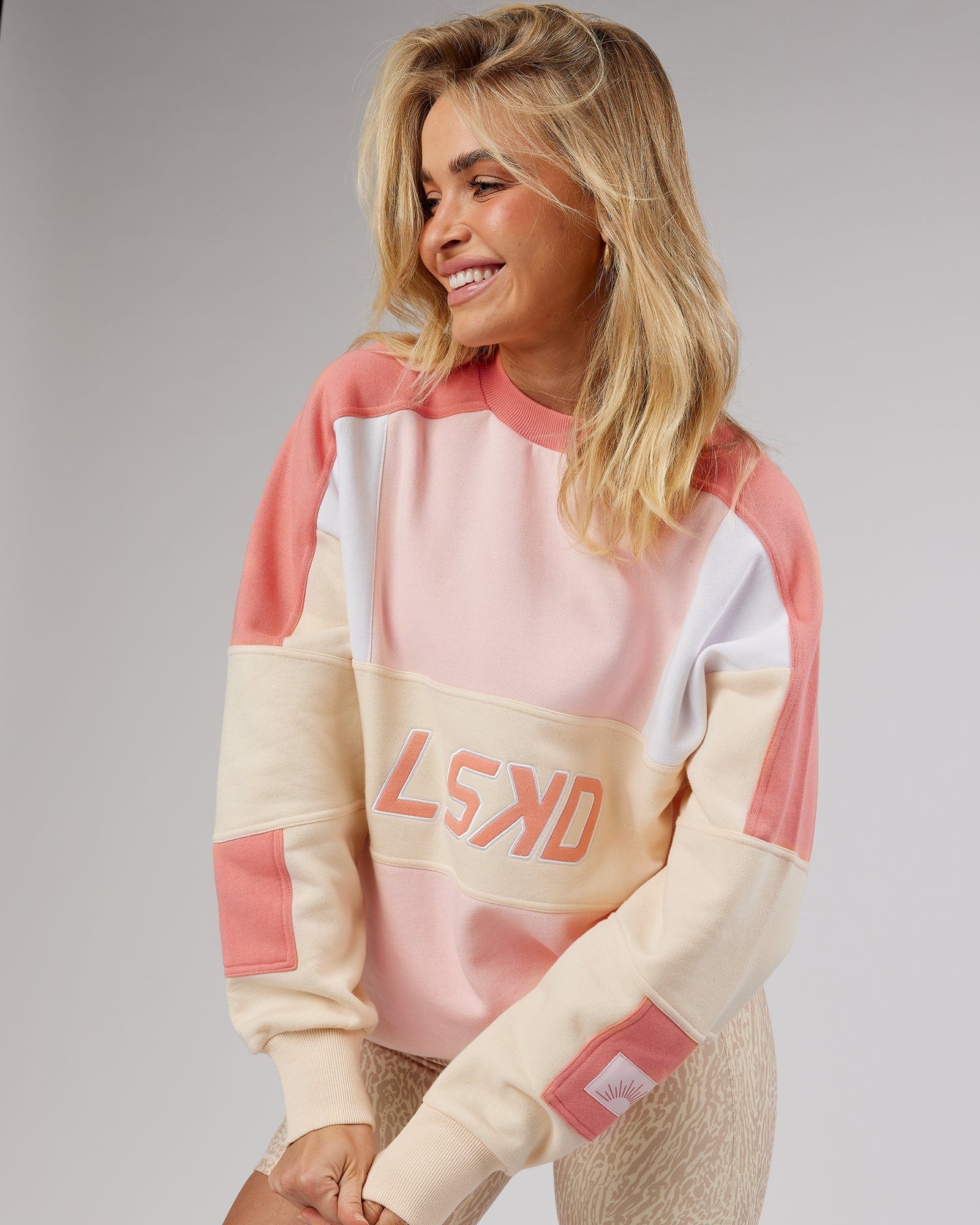 Model wearing Unisex Slam Oversize Sweater - Peach Multi