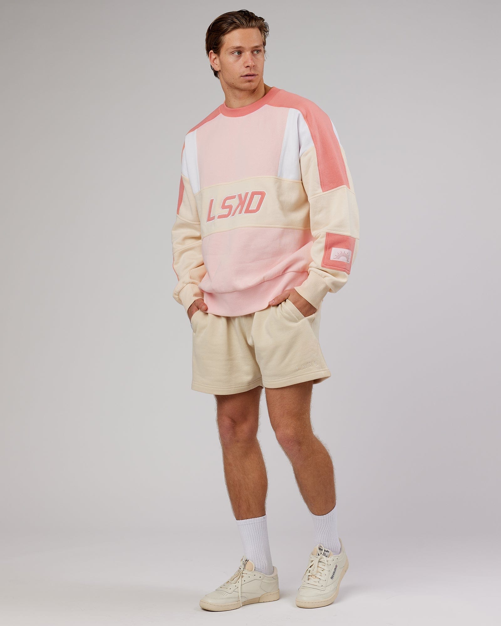 Model wearing Rise Track Short - Classic Cream