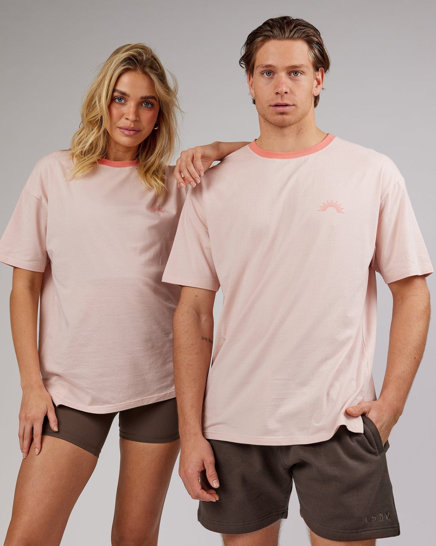 Model wearing Unisex Rise FLXCotton Oversize Tee - Peach Flush