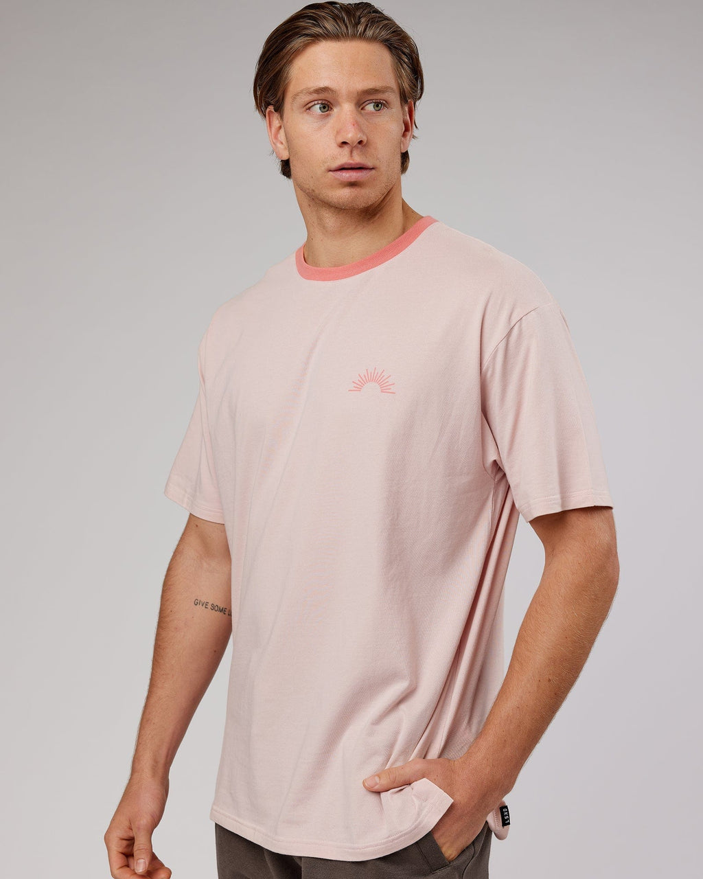 Model wearing Unisex Rise FLXCotton Oversize Tee - Peach Flush