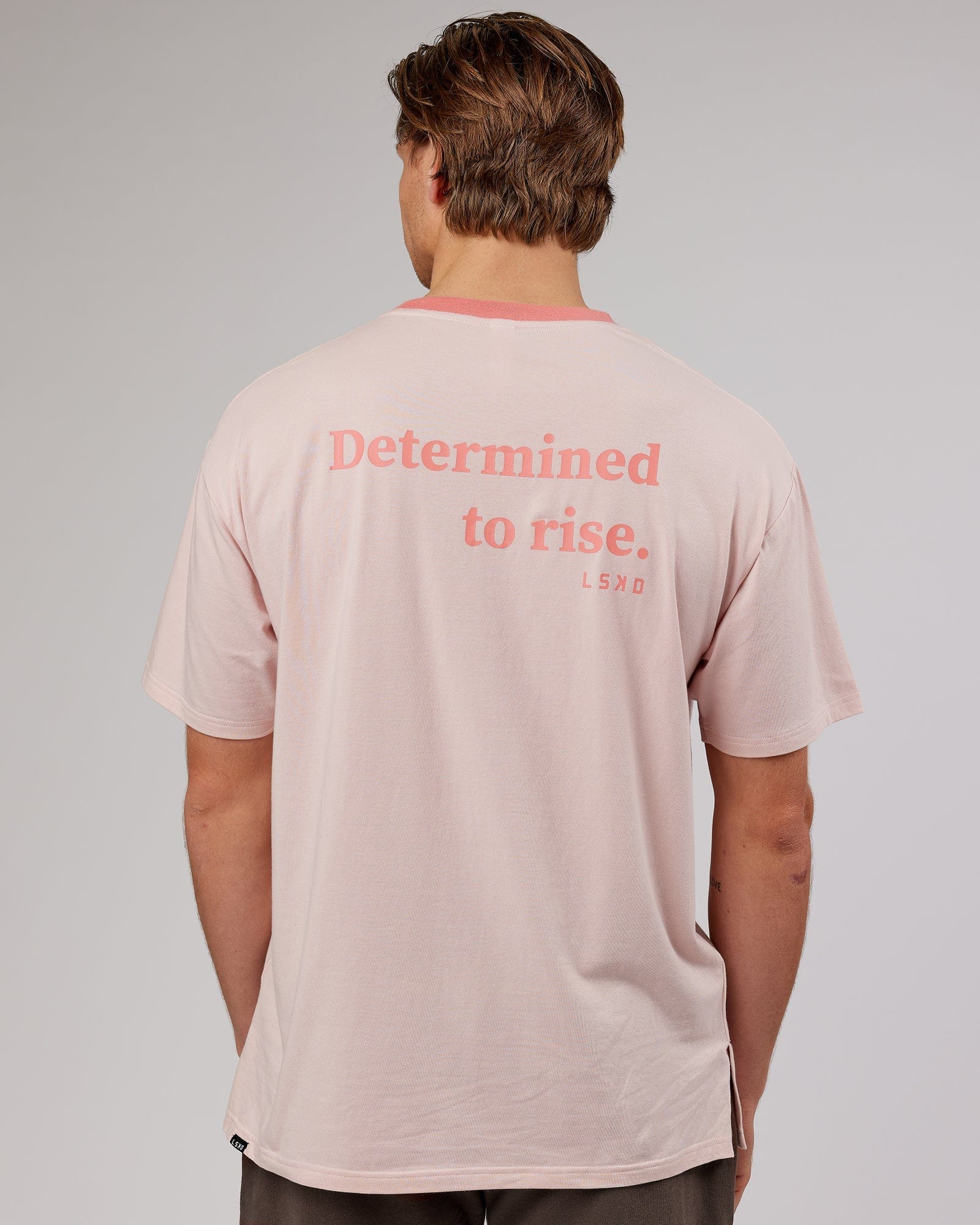 Model wearing Unisex Rise FLXCotton Oversize Tee - Peach Flush