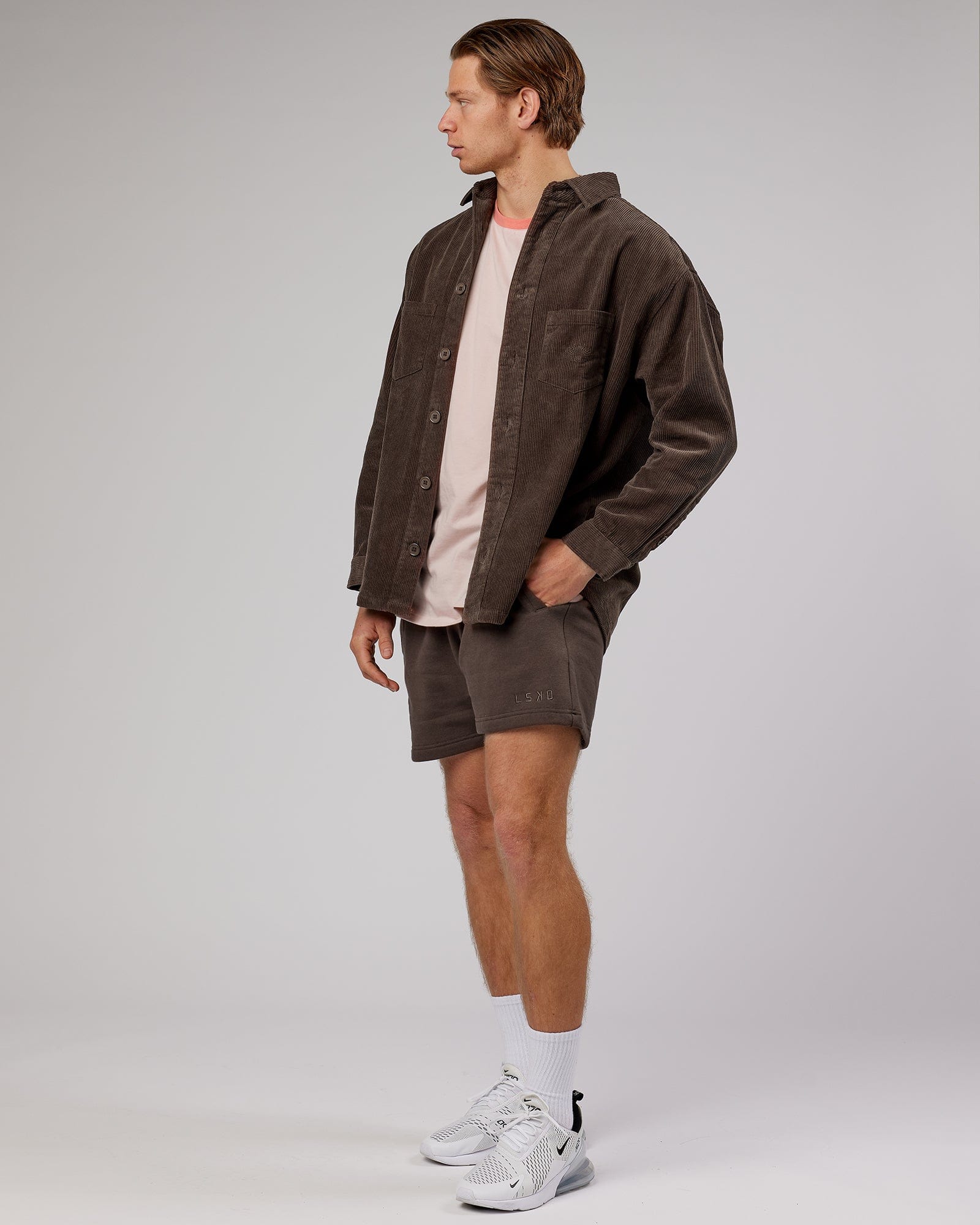 Model wearing Unisex Rise Cord Shacket - Mocha