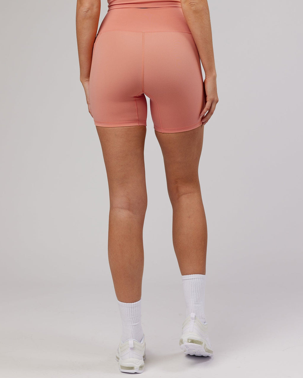 Model wearing Energise Mid Short Tight - Peach