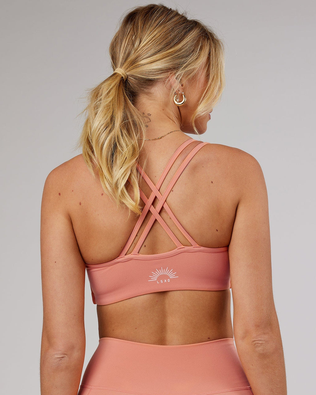 Model wearing Uplift Recycled Sports Bra - Peach