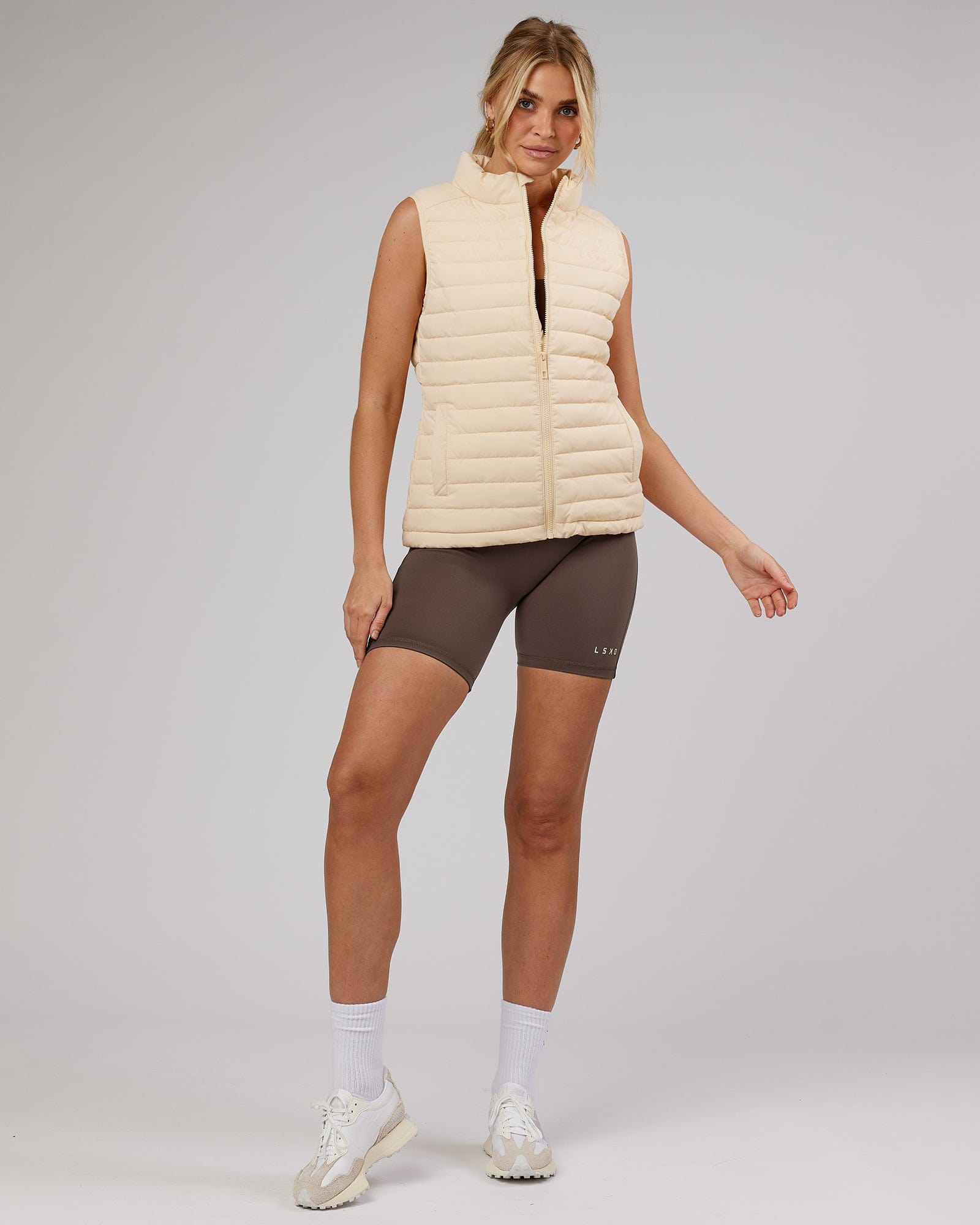 Model wearing Uplift Puffer Vest - Classic Cream