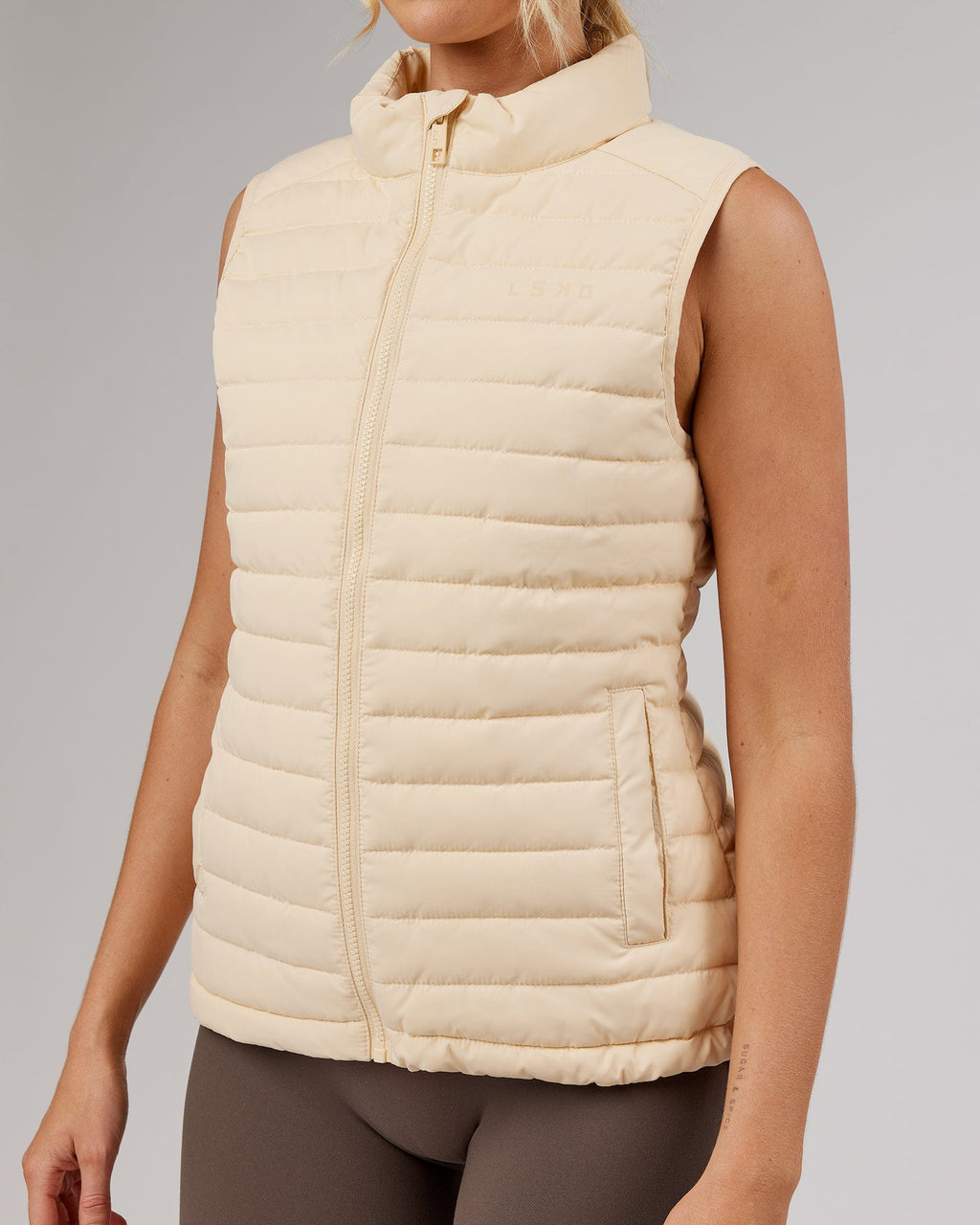Model wearing Uplift Puffer Vest - Classic Cream