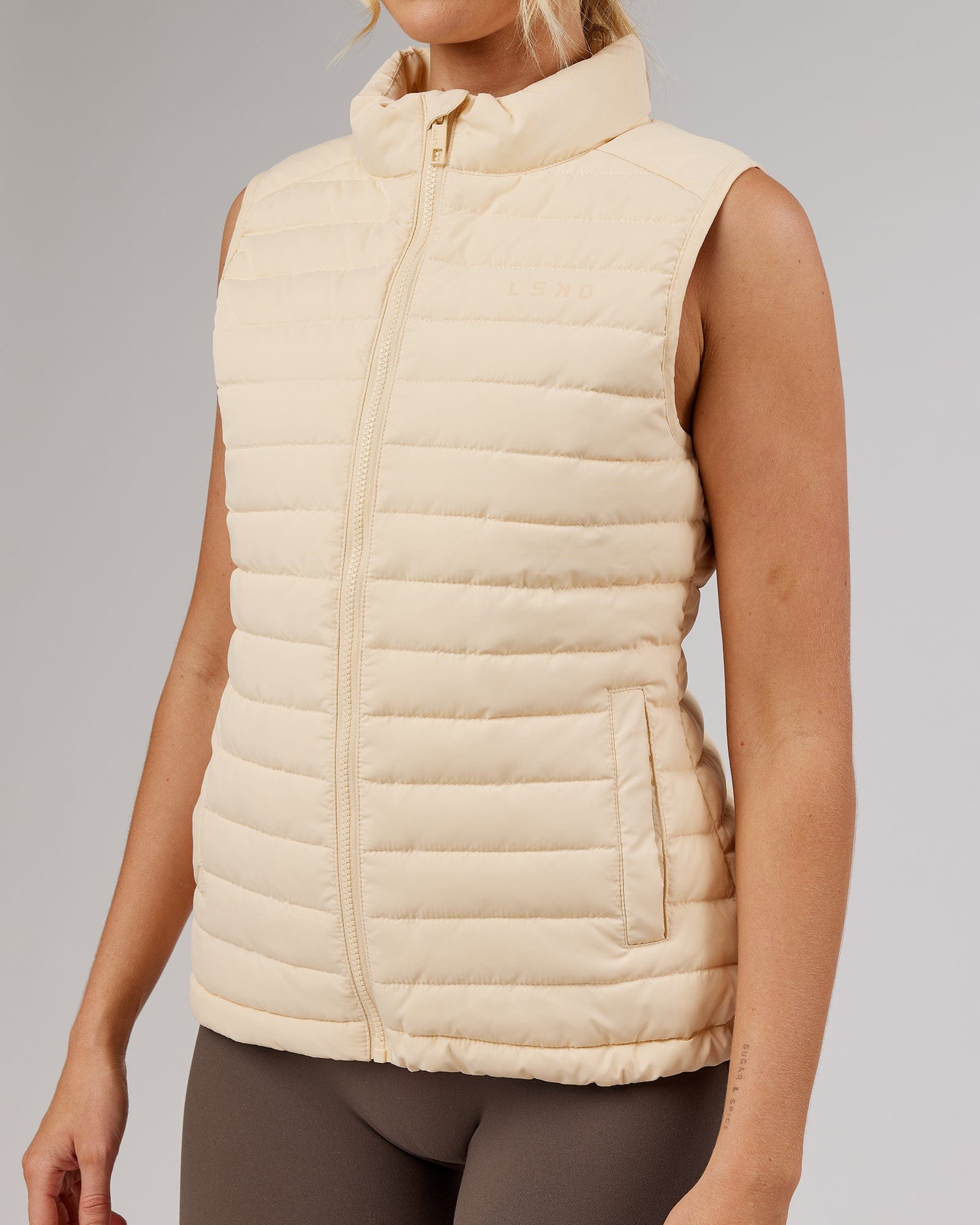 Model wearing Uplift Puffer Vest - Classic Cream