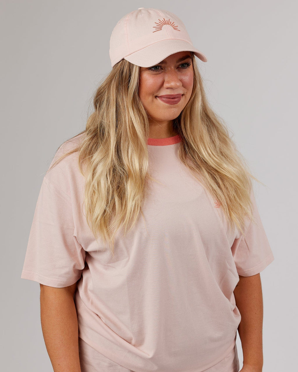 Model wearing Rise Cap - Peach Flush