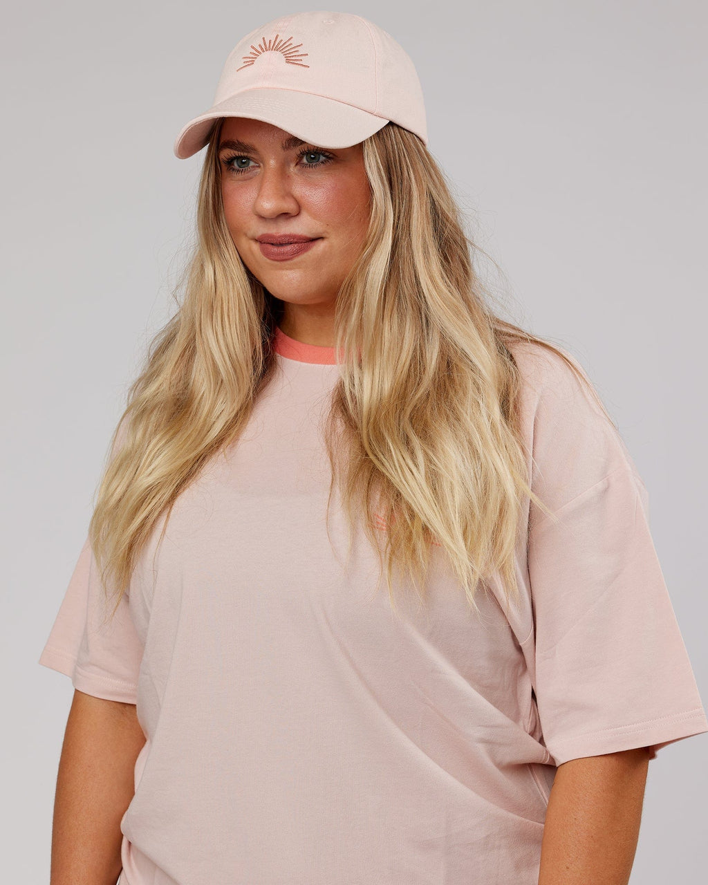 Model wearing Rise Cap - Peach Flush