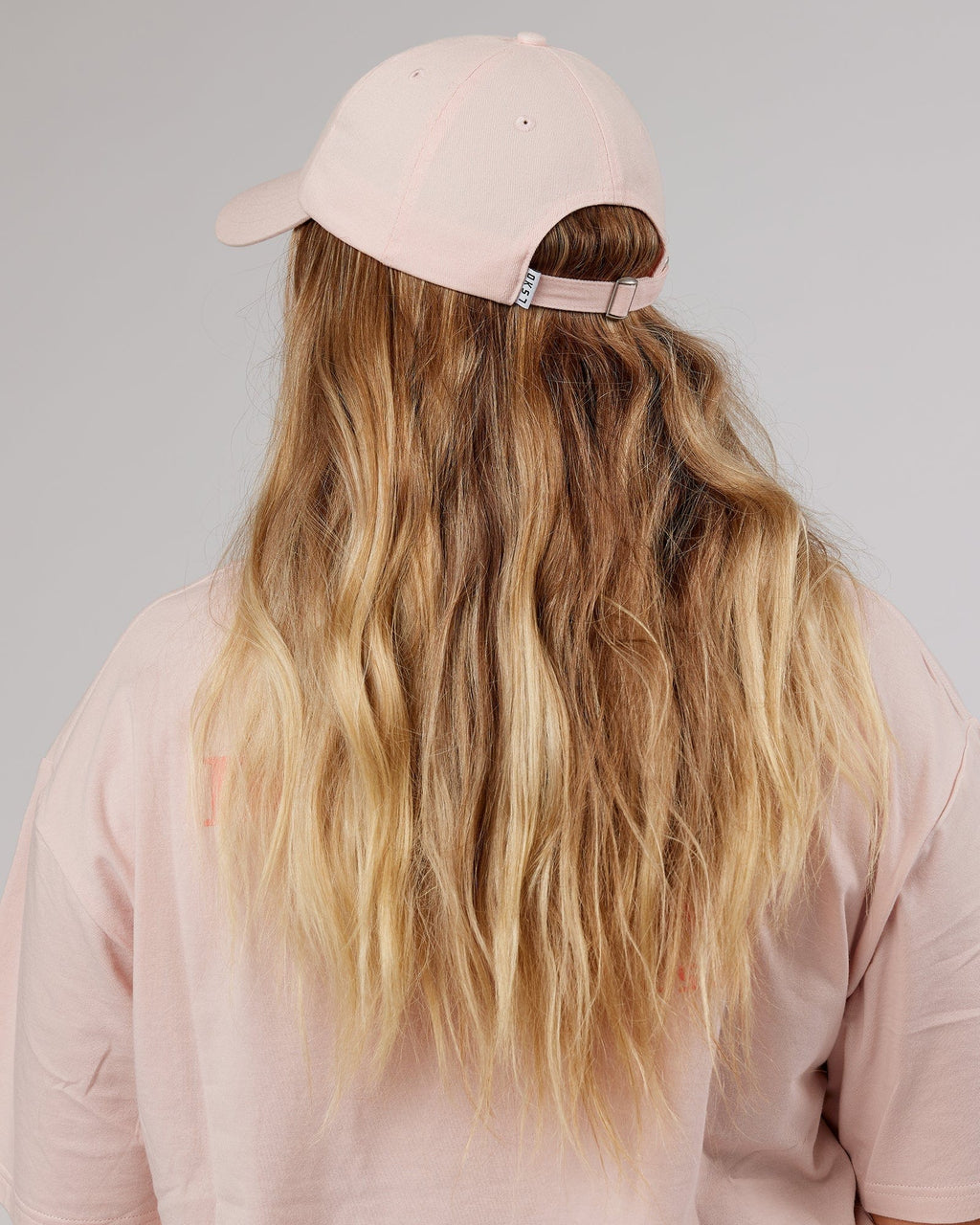 Model wearing Rise Cap - Peach Flush