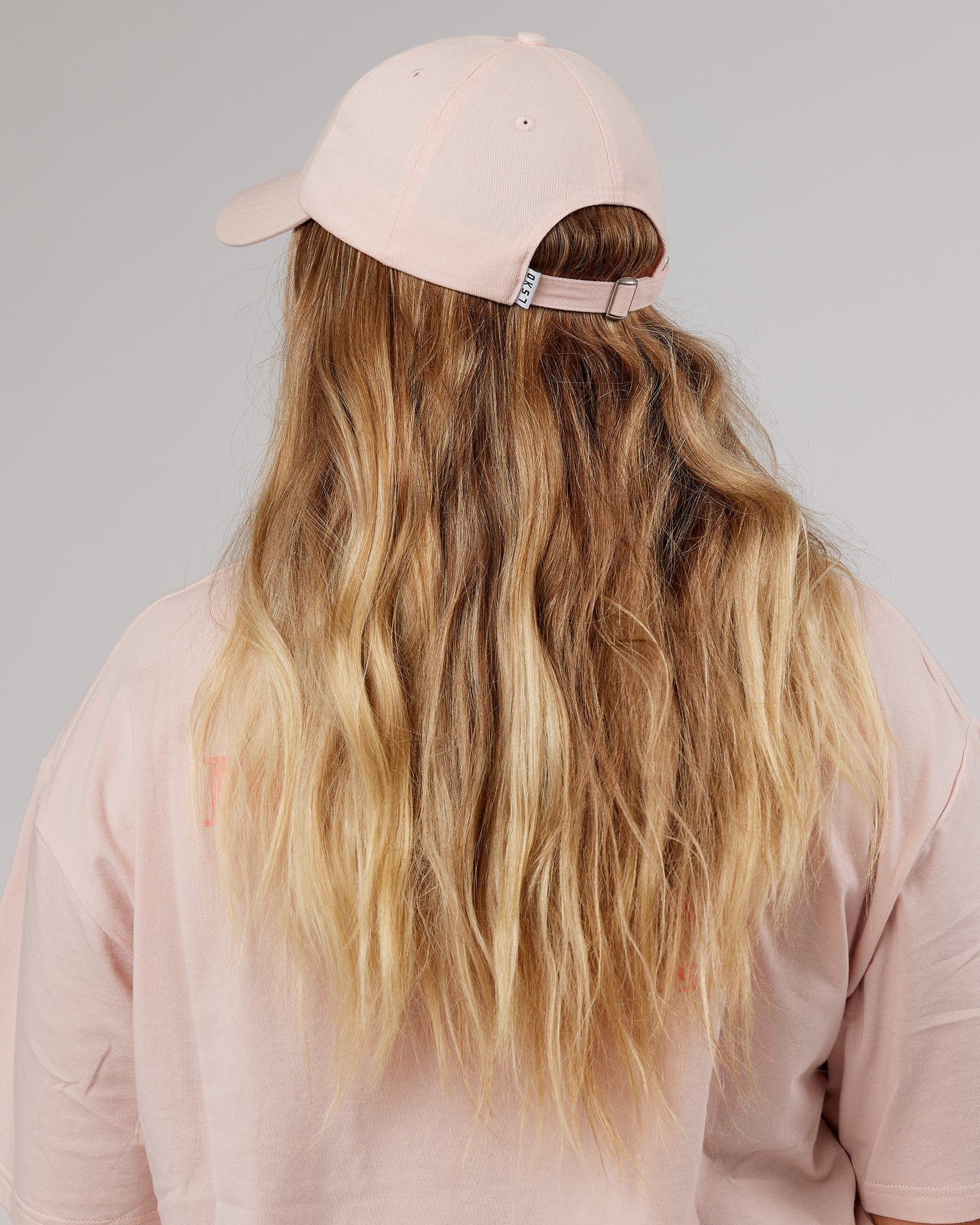 Model wearing Rise Cap - Peach Flush