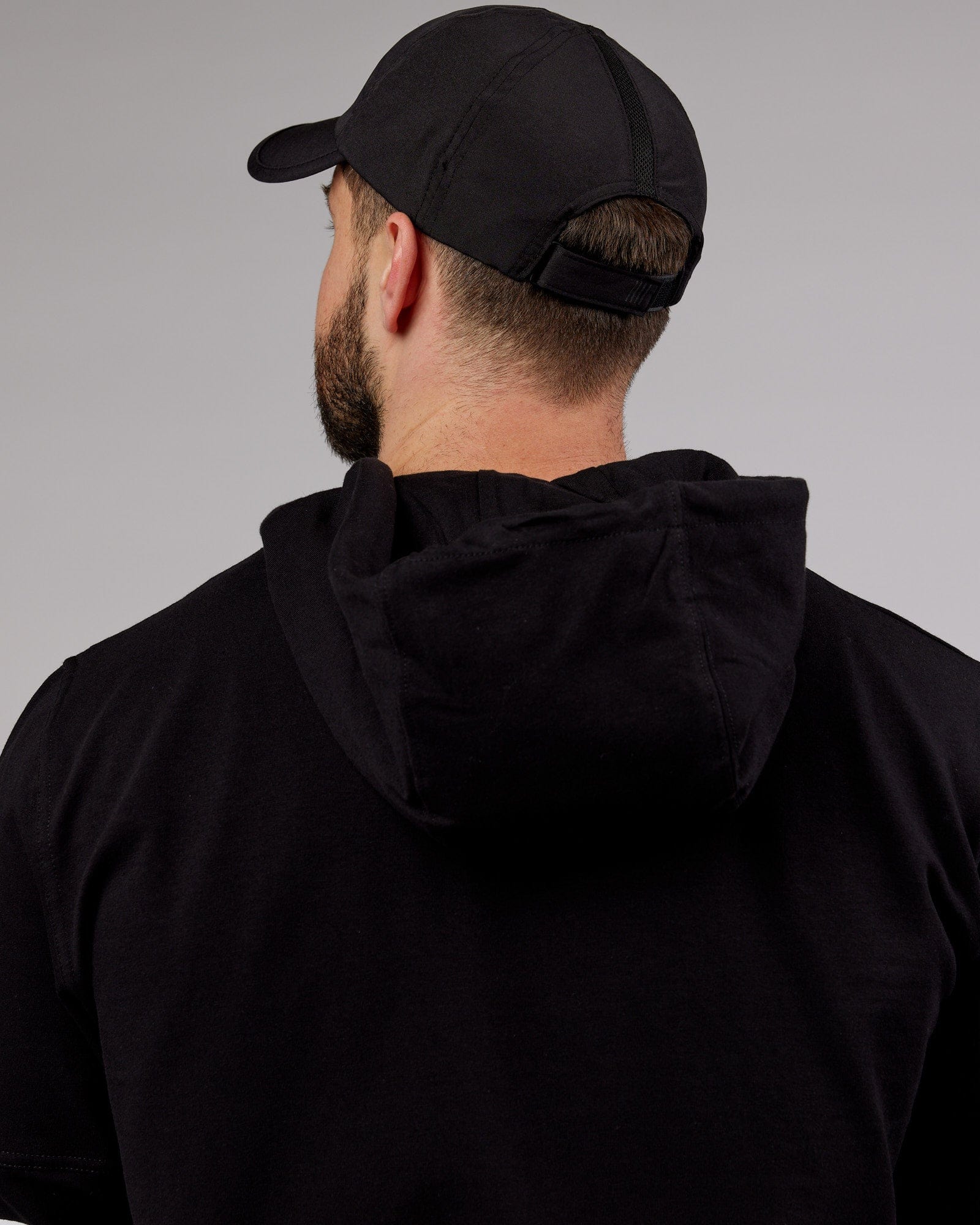 Model wearing Performance Tech Cap - Black
