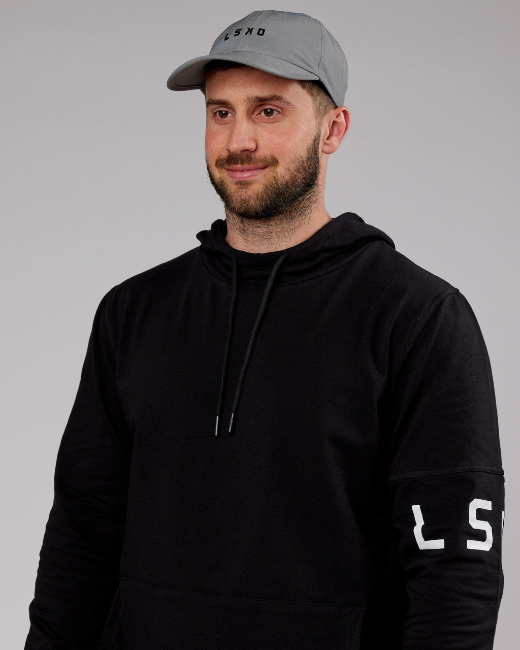 Model wearing Performance Tech Cap - Alloy