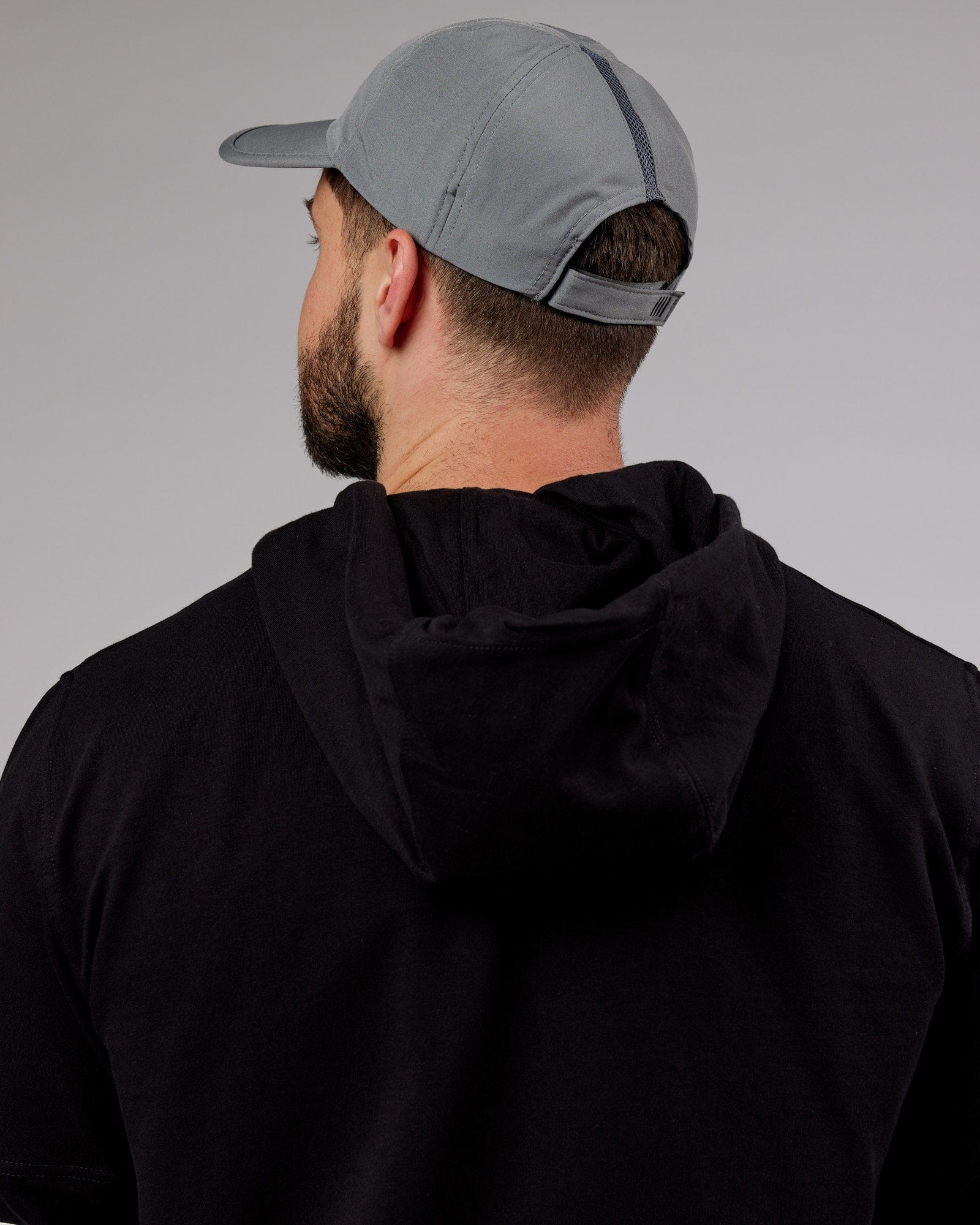 Model wearing Performance Tech Cap - Alloy