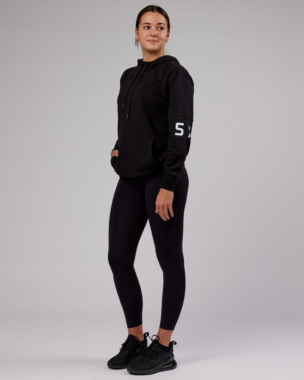 Model wearing Unisex Perimeter FLXFleece Hoodie - Black