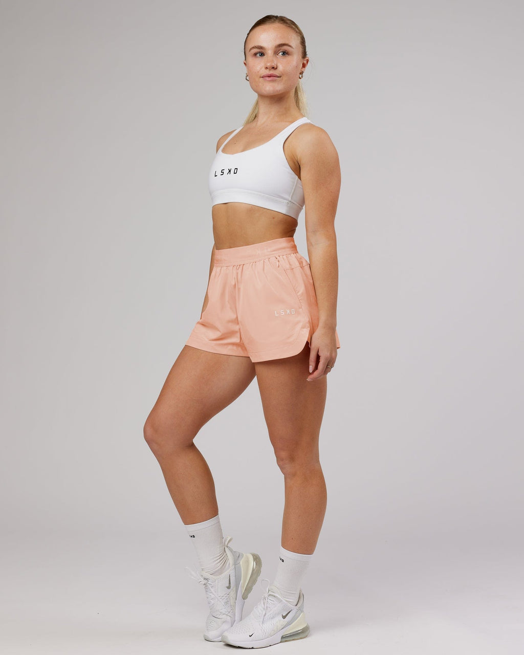 Model wearing Competition Linerless Performance Short - Pink