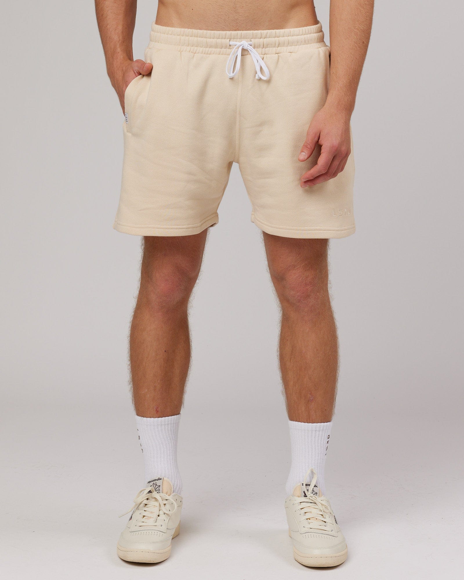 Model wearing Rise Track Short - Classic Cream