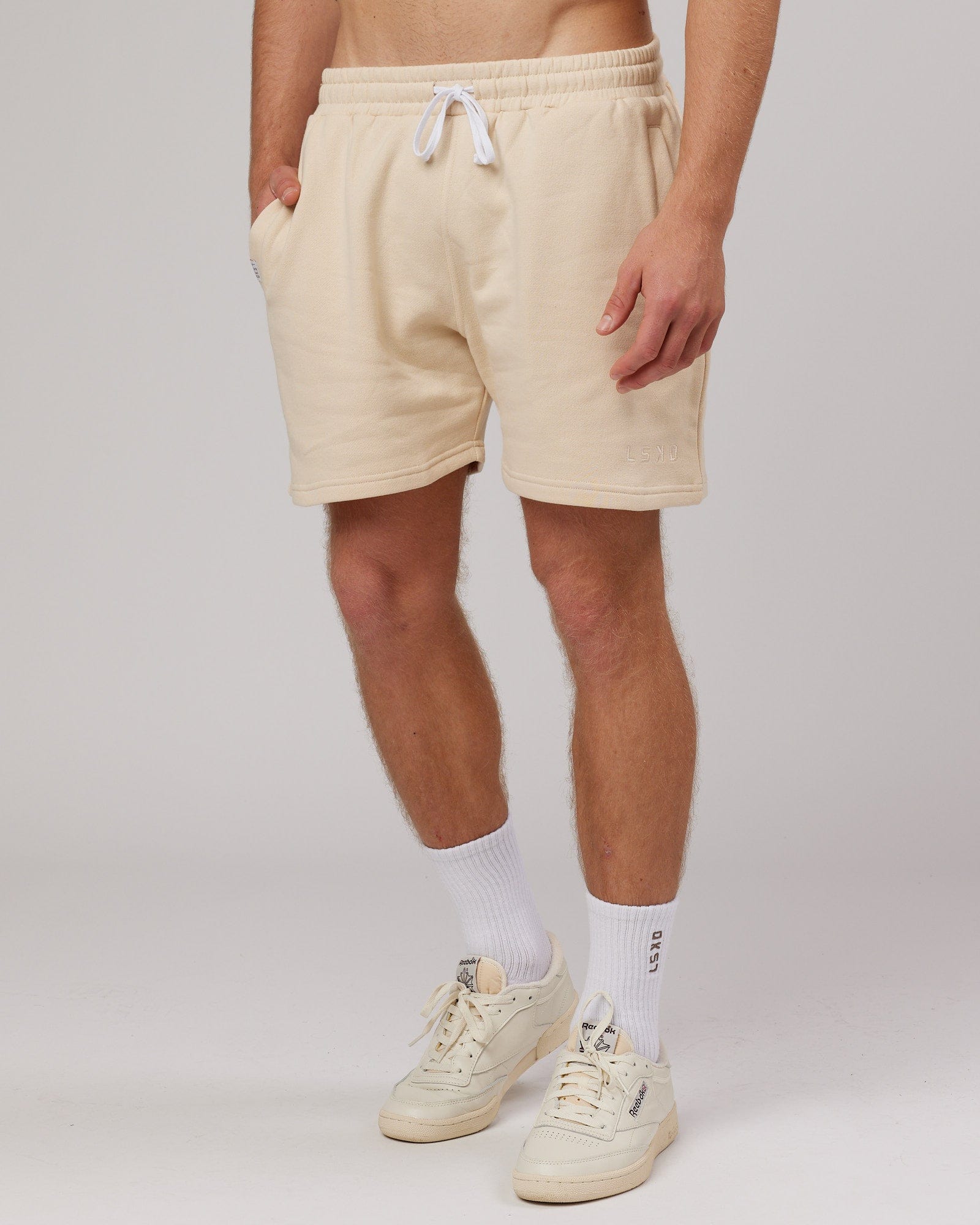 Model wearing Rise Track Short - Classic Cream