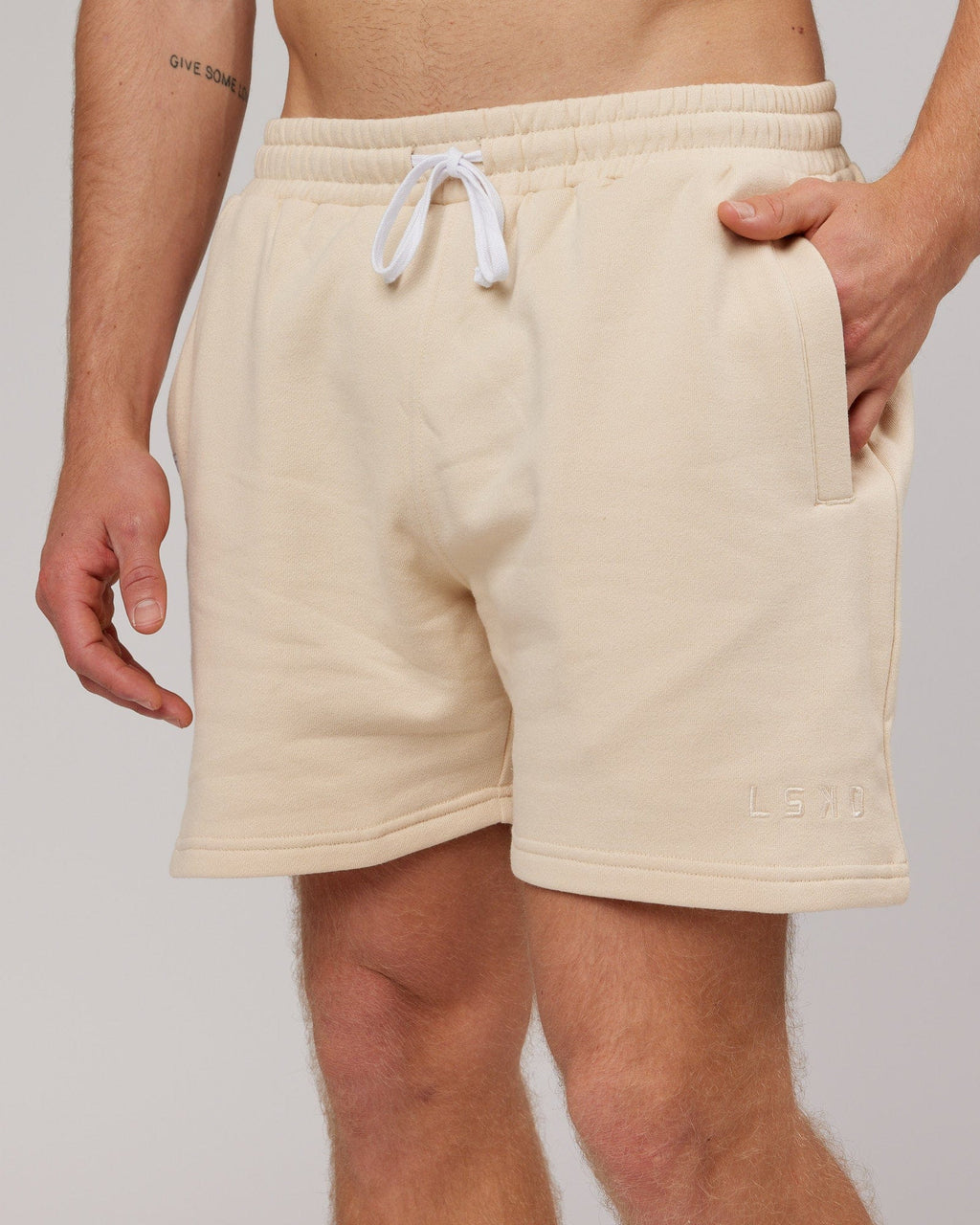 Model wearing Rise Track Short - Classic Cream