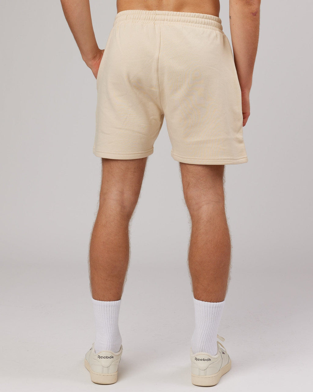 Model wearing Rise Track Short - Classic Cream