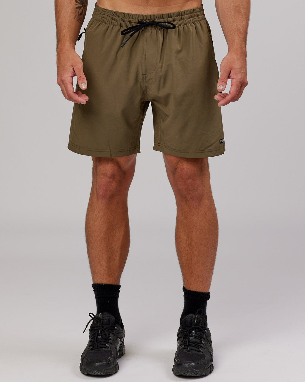Model wearing Rep 7'' Performance Short - Army Green