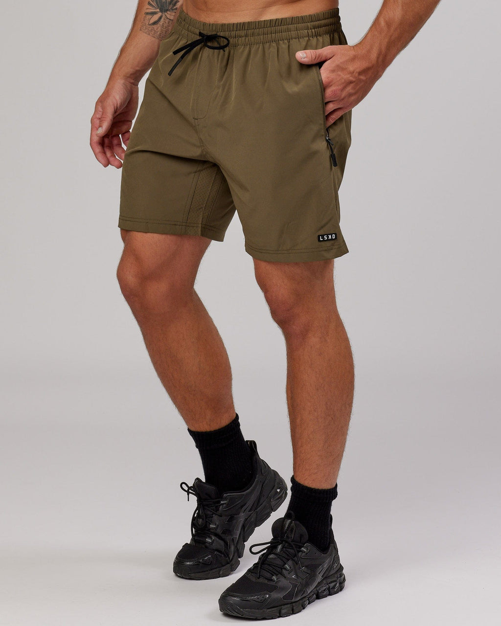 Model wearing Rep 7'' Performance Short - Army Green
