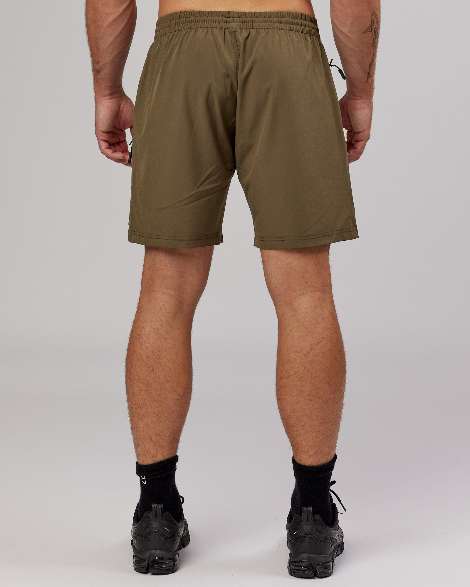 Model wearing Rep 7'' Performance Short - Army Green