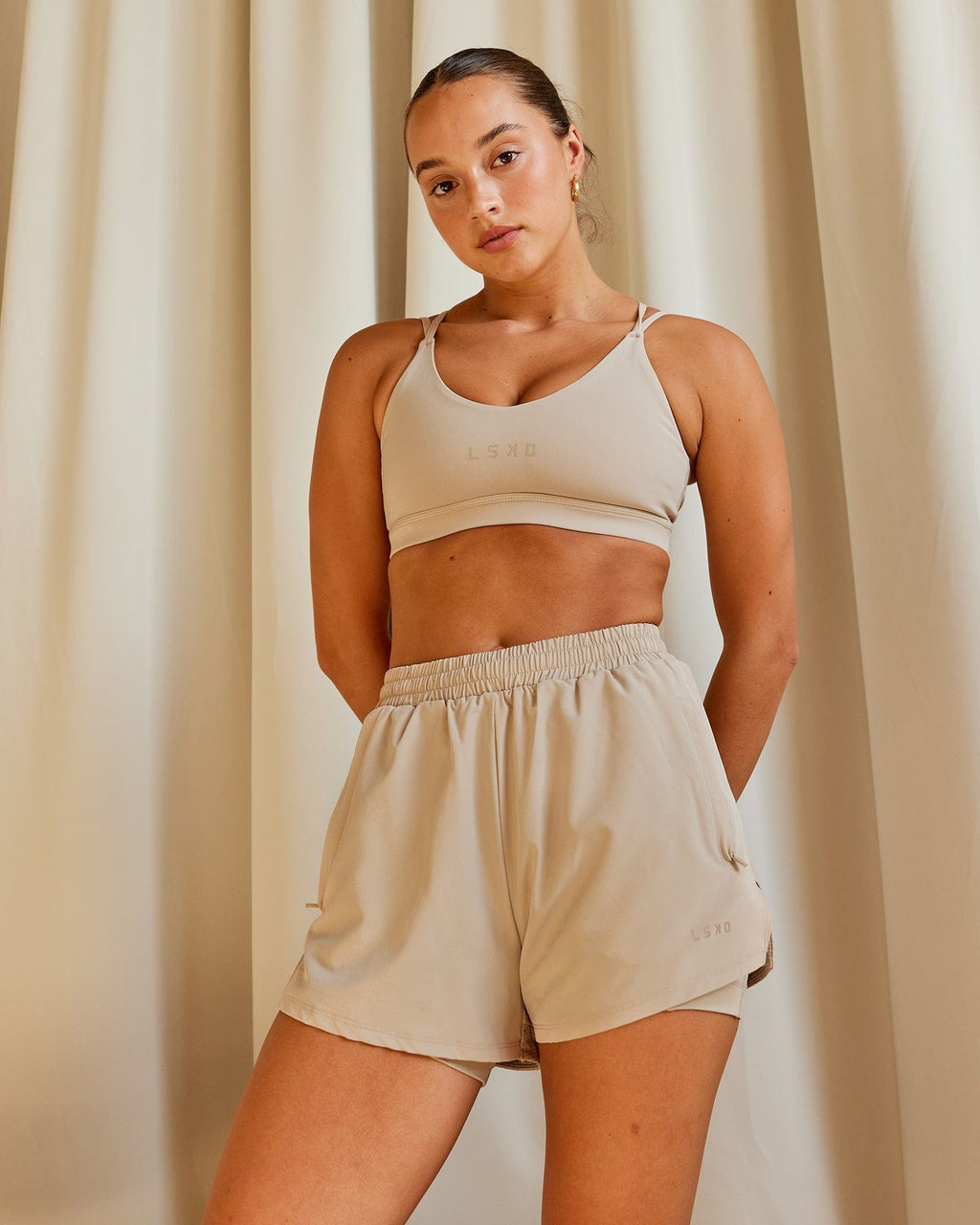 Model wearing Movement Sports Bra - Taupe