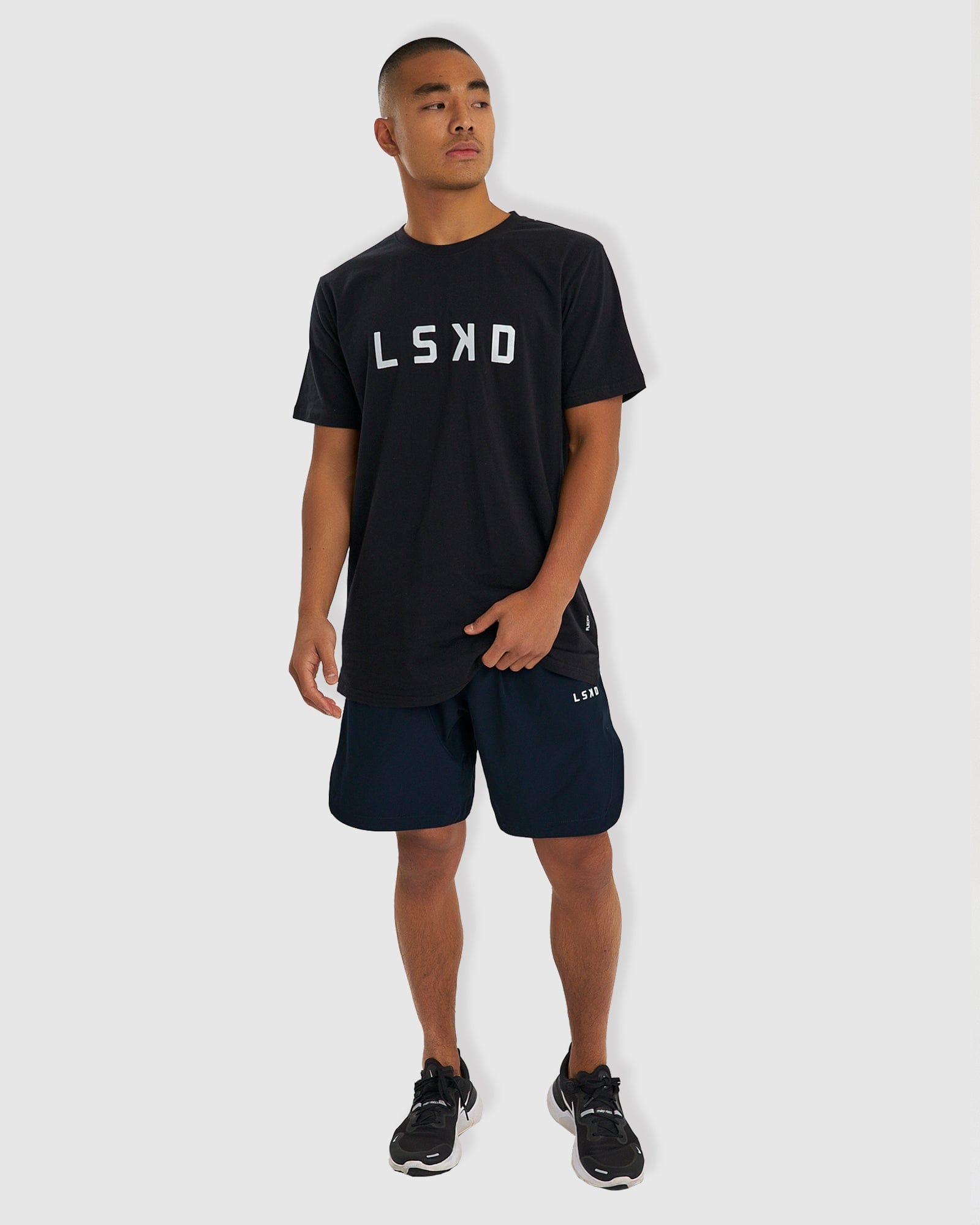 Model wearing Competition 8" Performance Short - Carbon