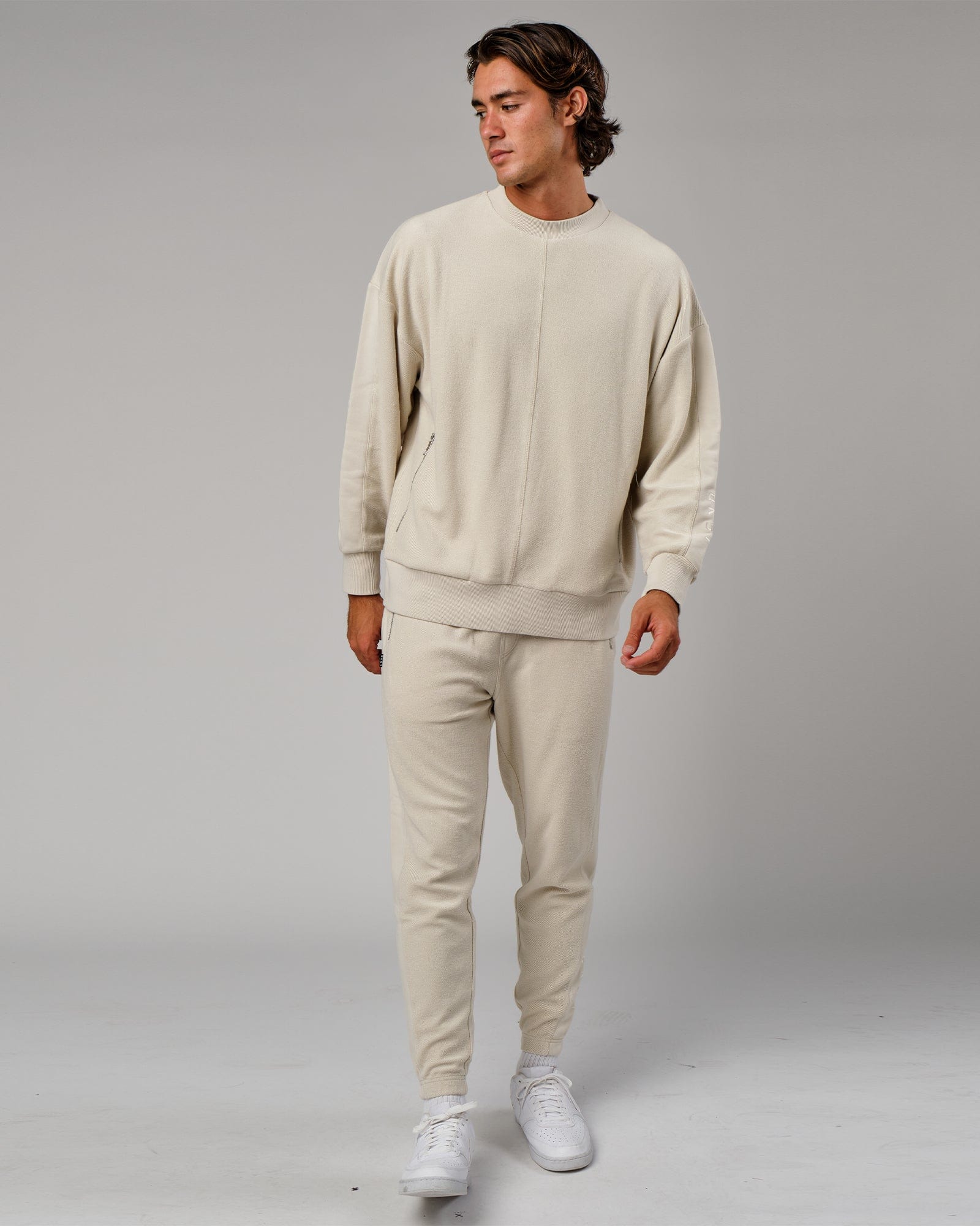 Model wearing Therma Track Pant - Bone