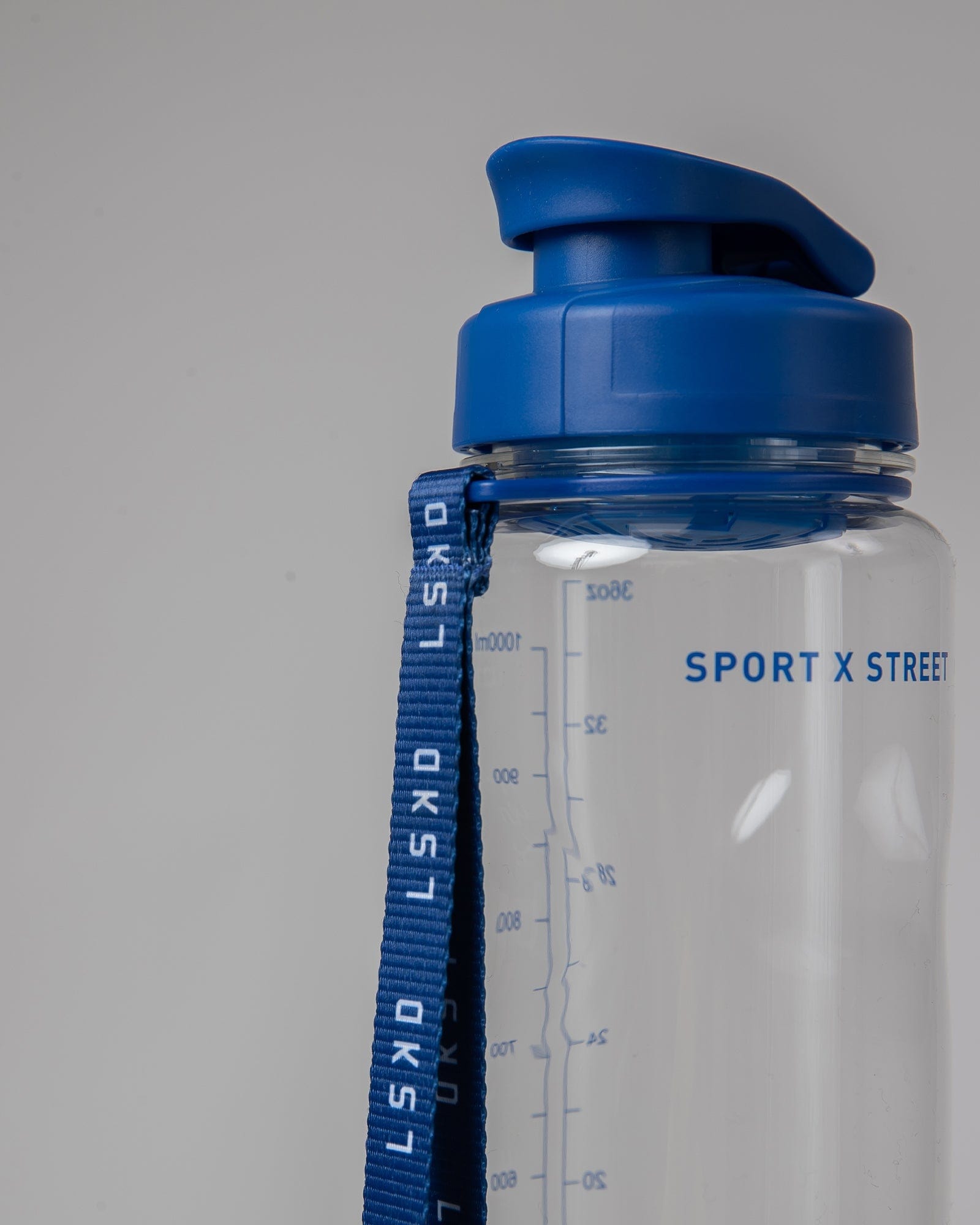 Model wearing Rep 1L Plastic Bottle - Turkish Sea-Clear