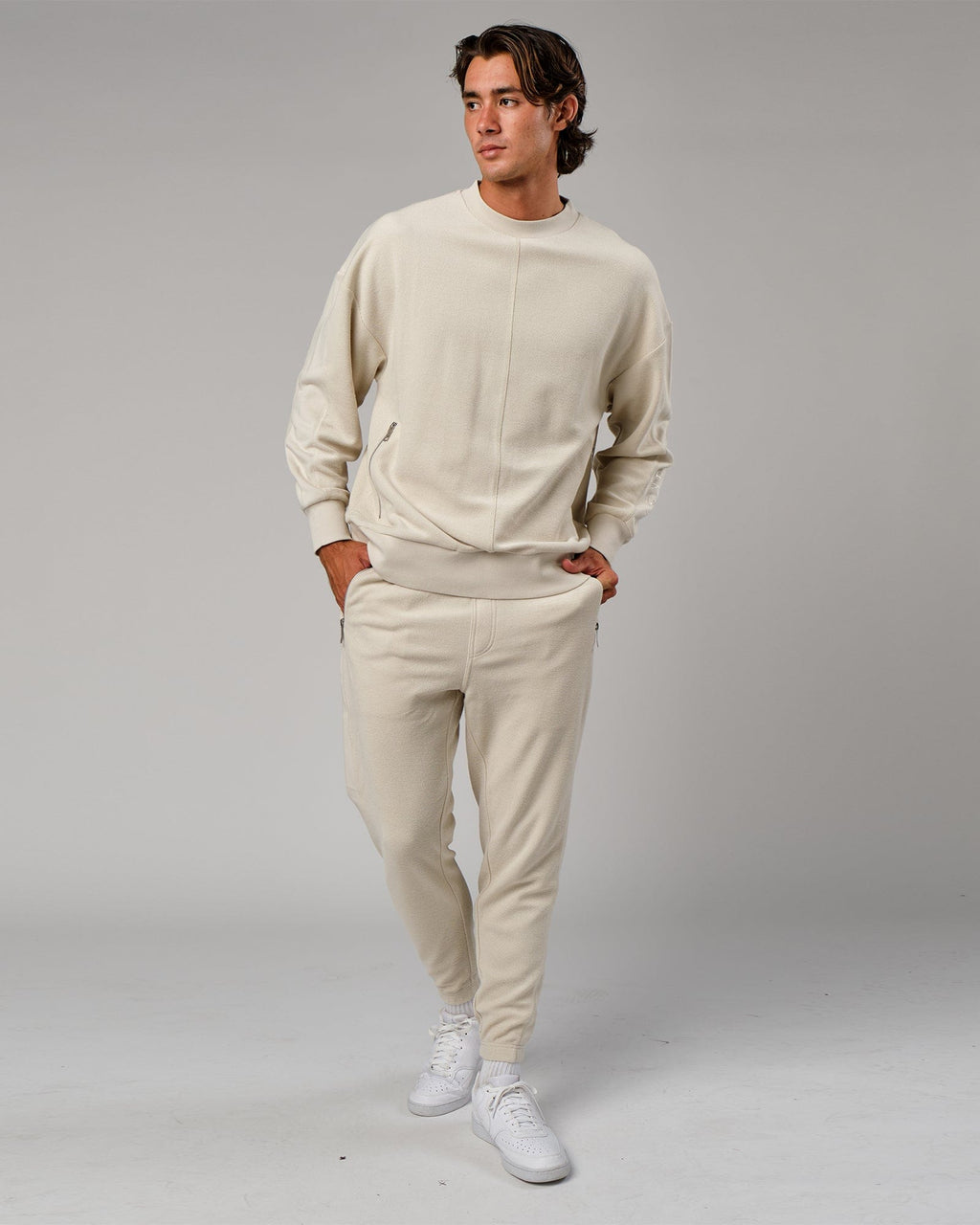 Model wearing Therma Track Pant - Bone