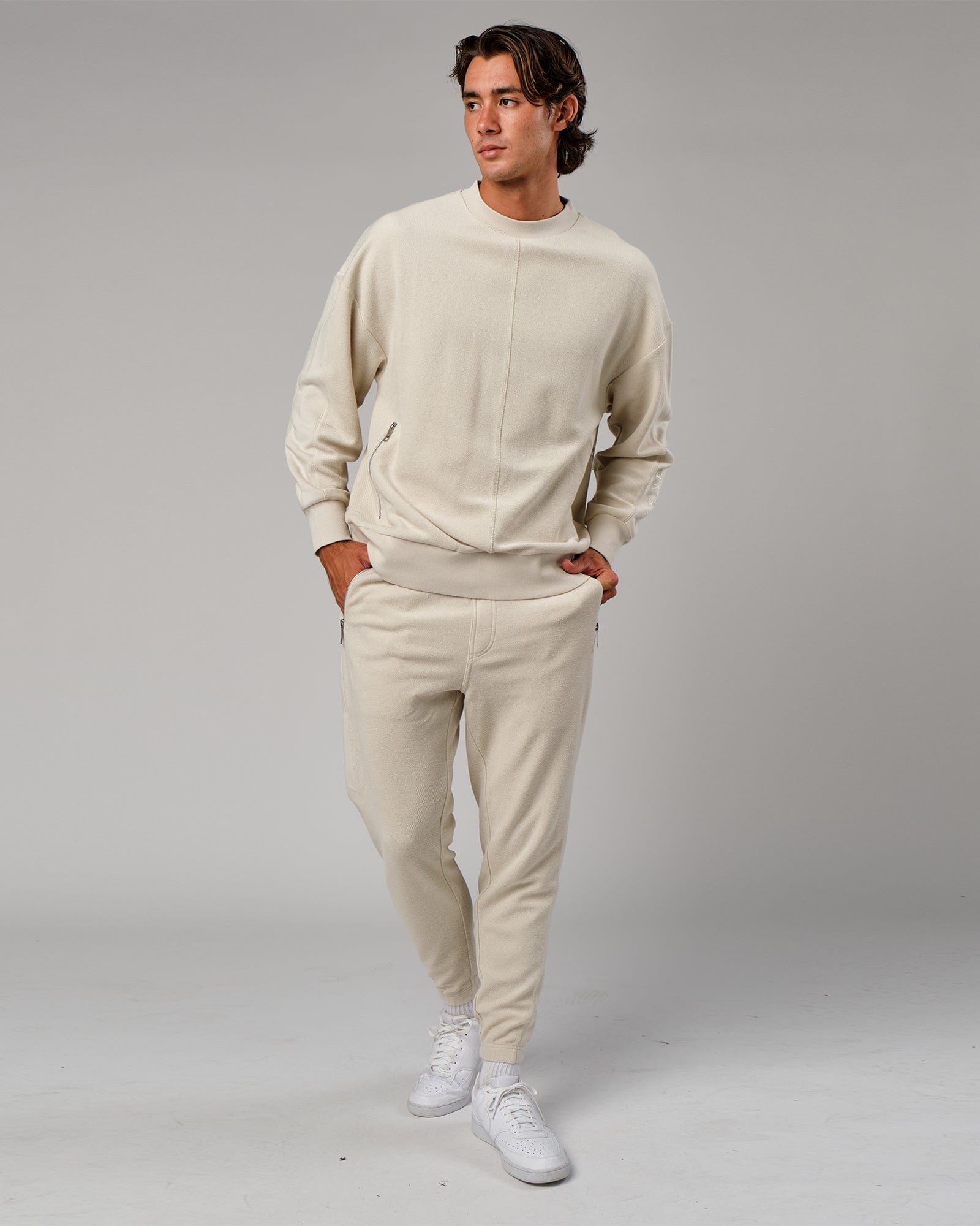 Model wearing Therma Track Pant - Bone