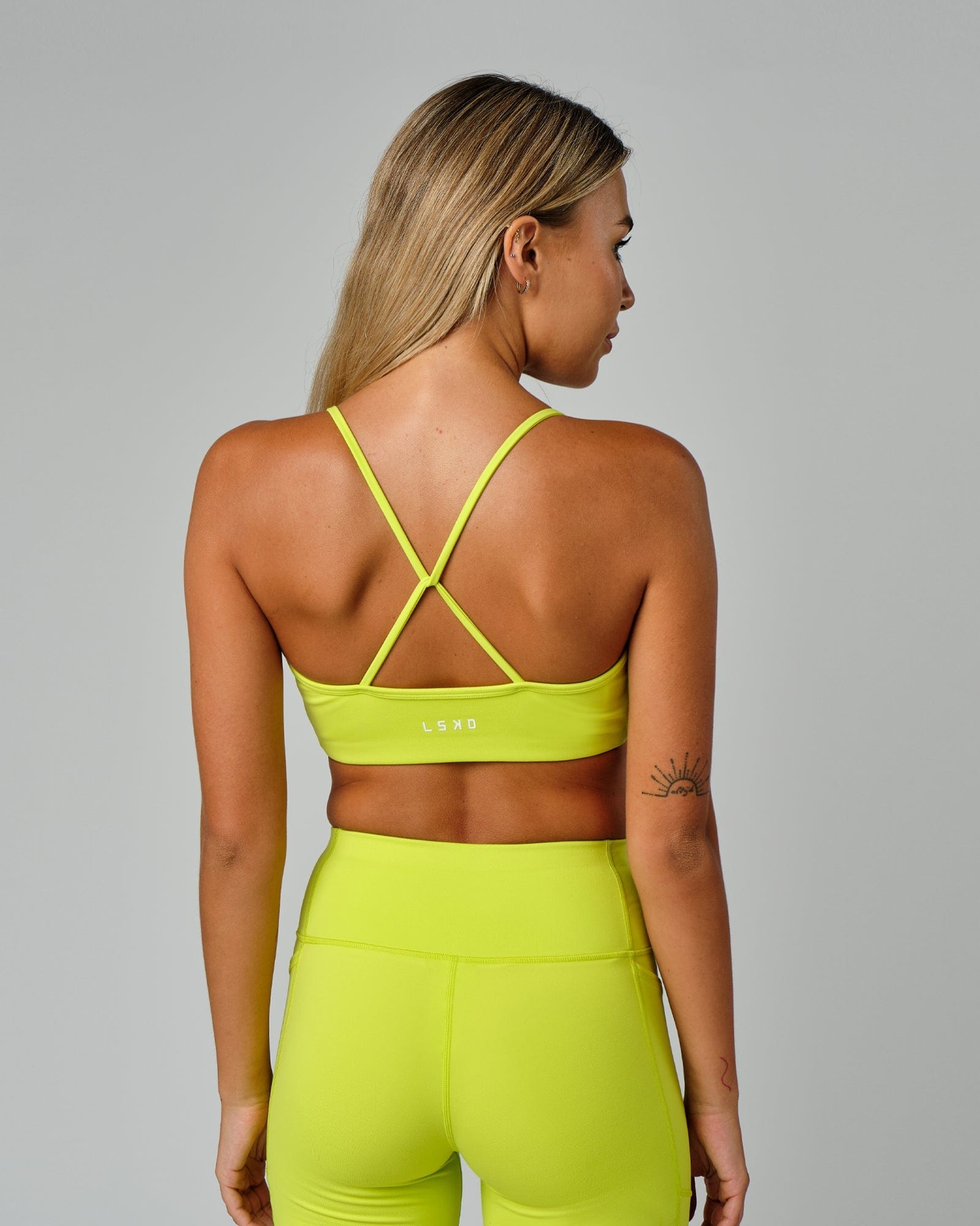 Model wearing Form Sports Bra - Fluro Lime