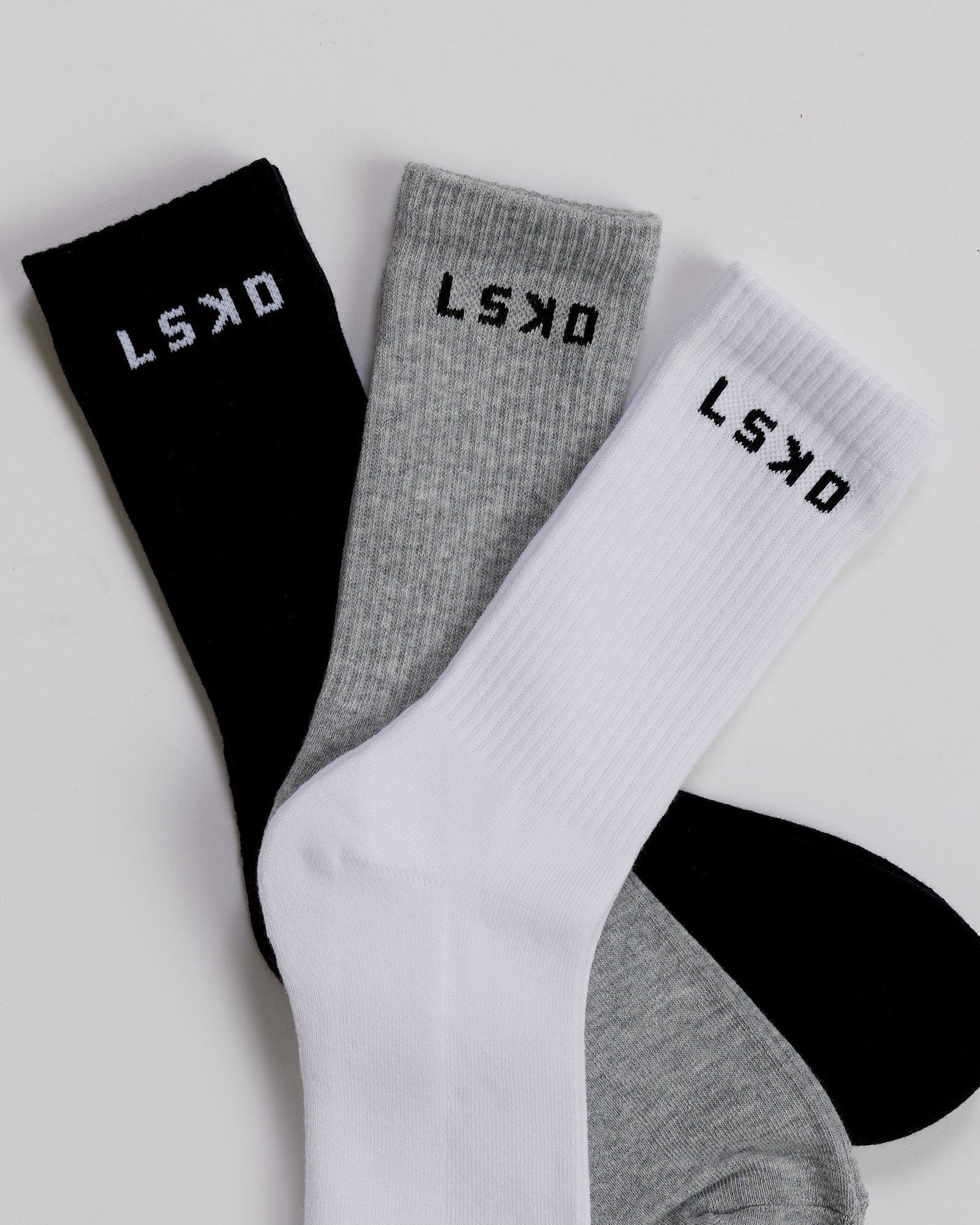 Model wearing Daily 3 Pack Crew Sock - Black/Grey/White