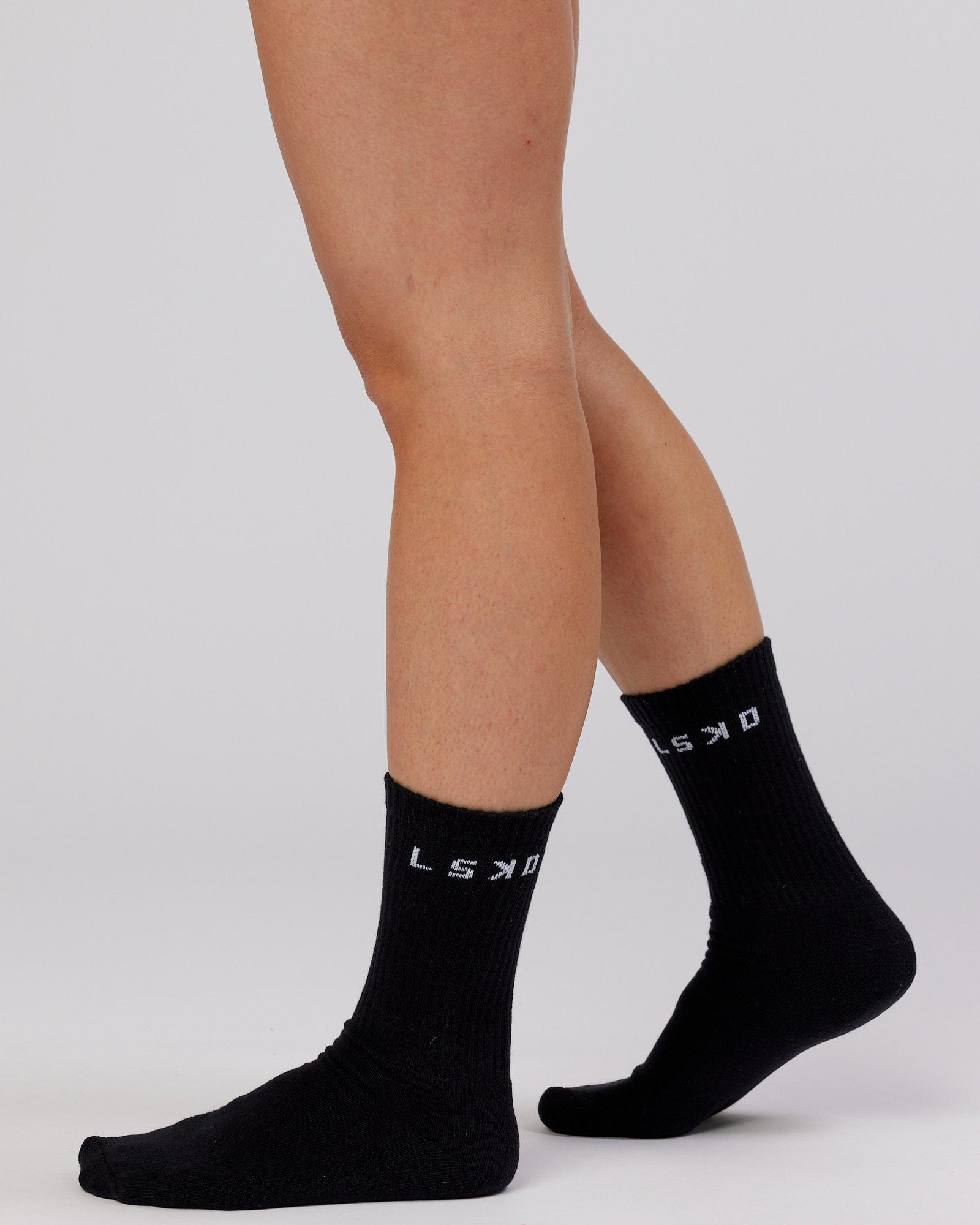 Model wearing Daily 3 Pack Crew Sock - Black/Grey/White
