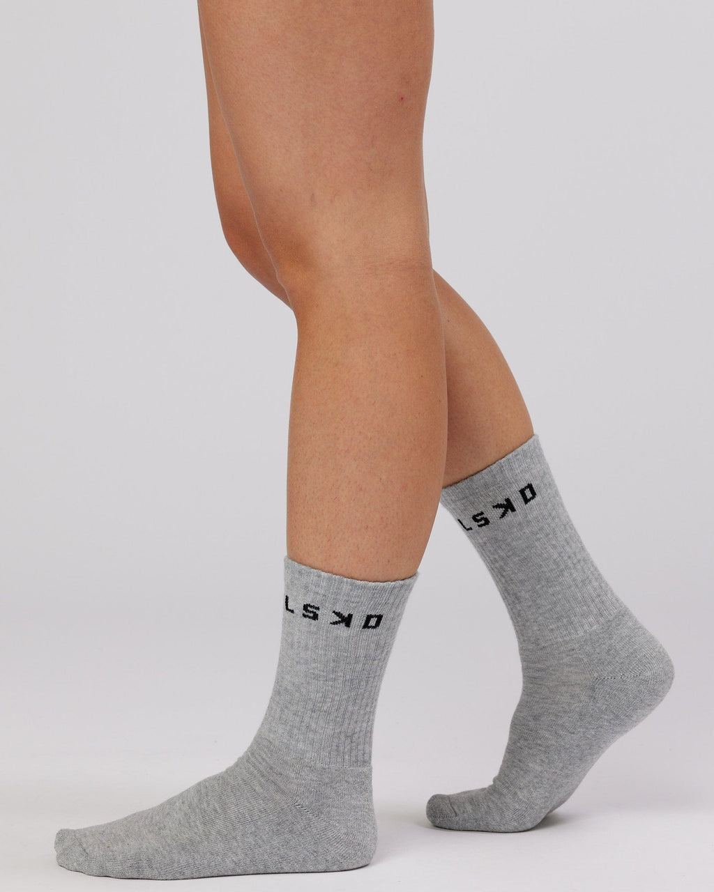 Model wearing Daily 3 Pack Crew Sock - Black/Grey/White