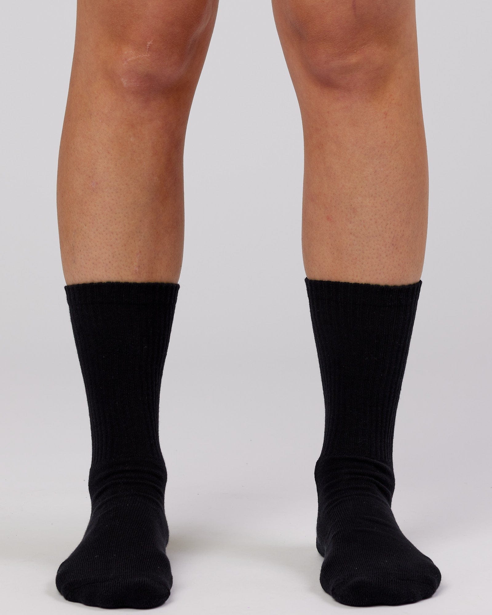 Model wearing Essential 3 Pack Crew Sock - Black