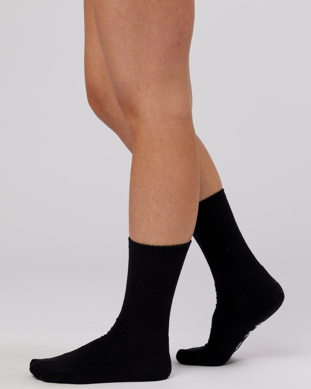 Model wearing Essential 3 Pack Crew Sock - Black
