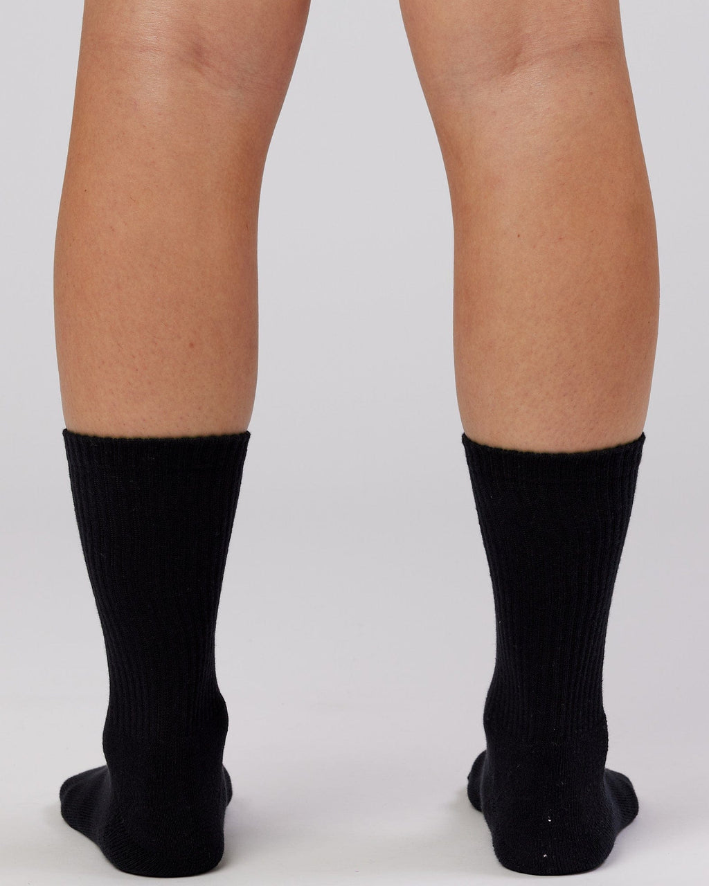 Model wearing Essential 3 Pack Crew Sock - Black