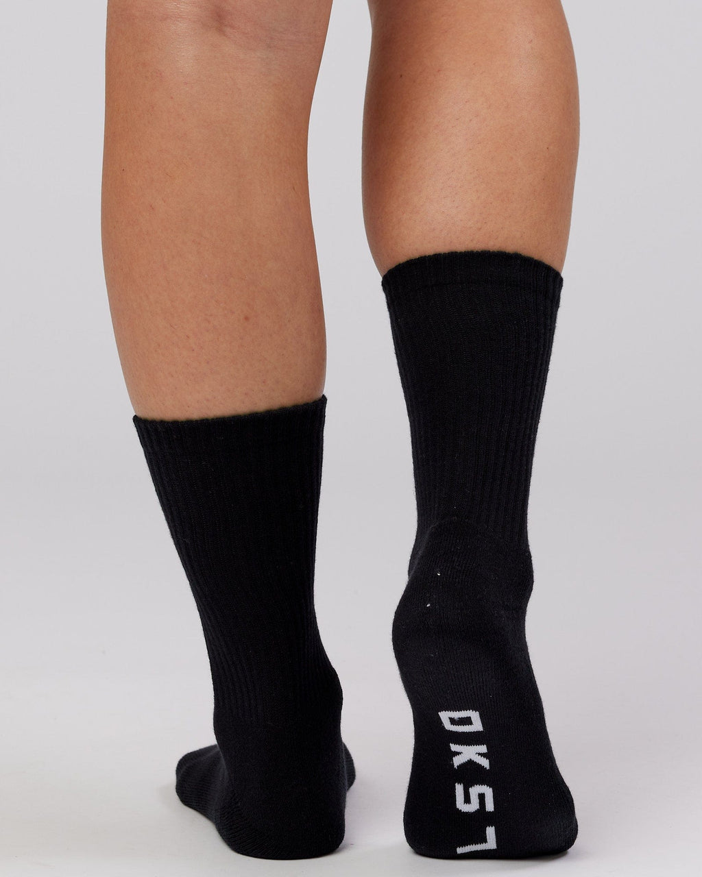 Model wearing Essential 3 Pack Crew Sock - Black
